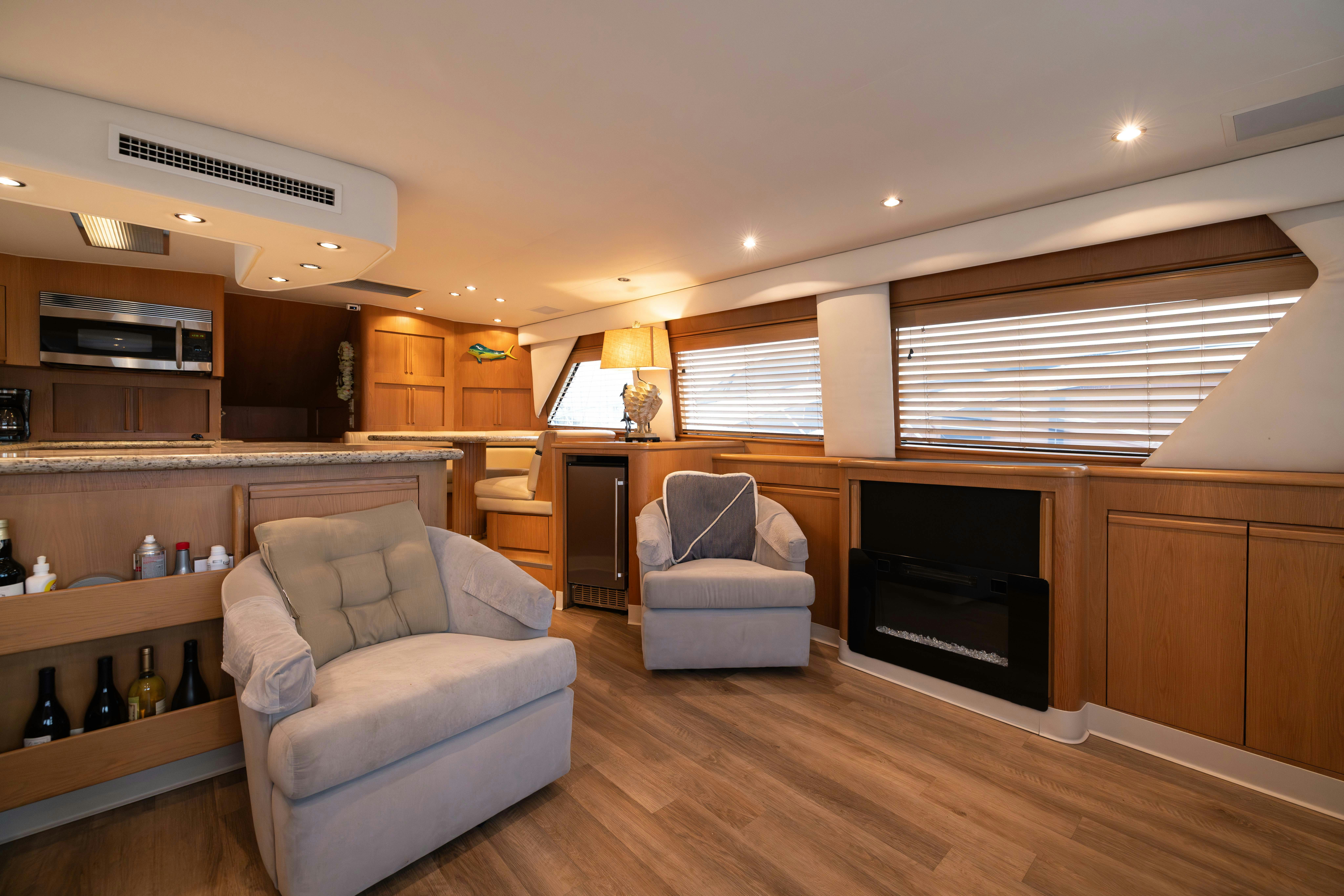 a living room with a fireplace aboard PREMIUM Yacht for Sale