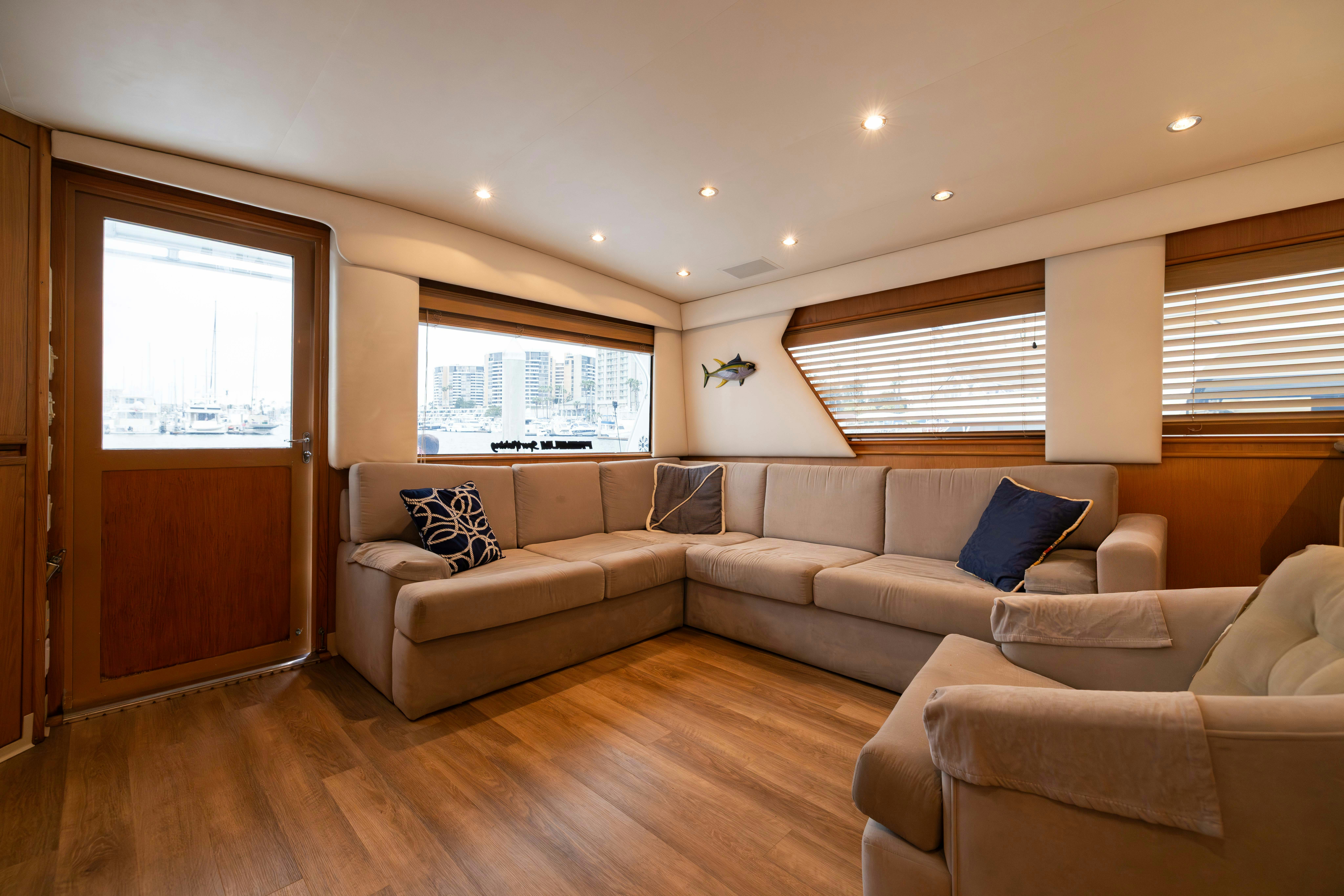 a living room with a couch and a wood door aboard PREMIUM Yacht for Sale