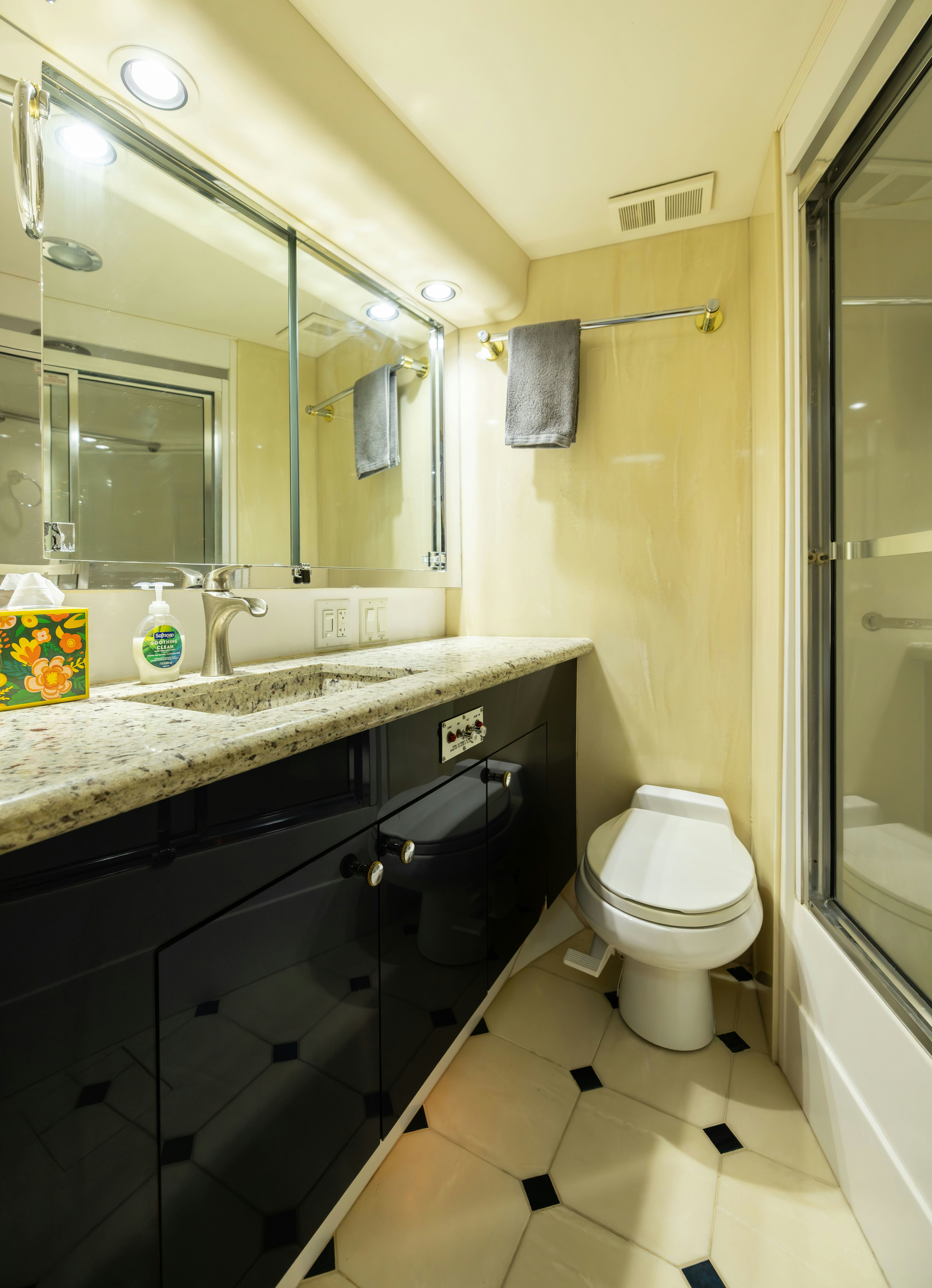 a bathroom with a sink toilet and a mirror aboard PREMIUM Yacht for Sale