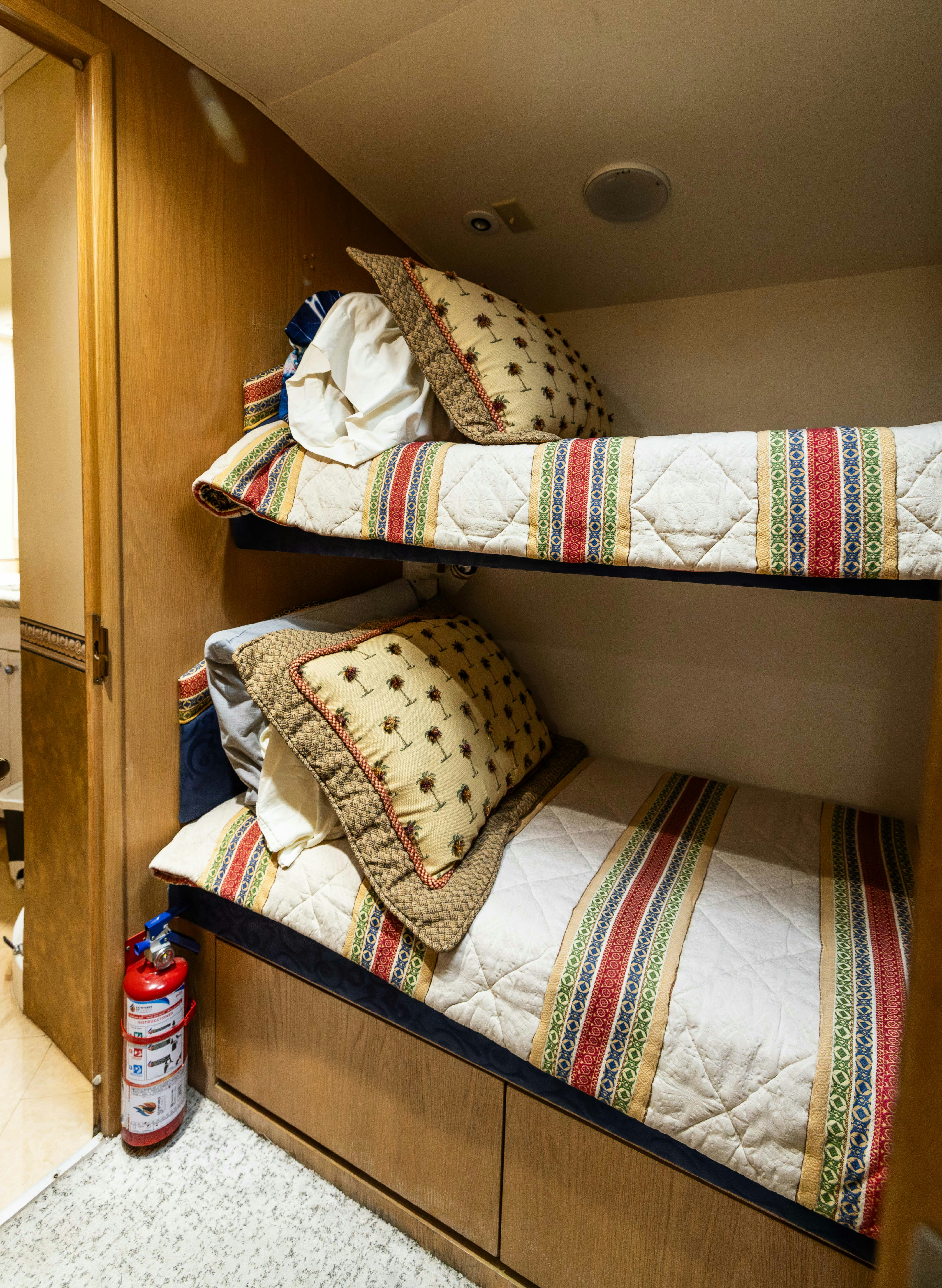 a bunk bed with a plaid blanket aboard PREMIUM Yacht for Sale