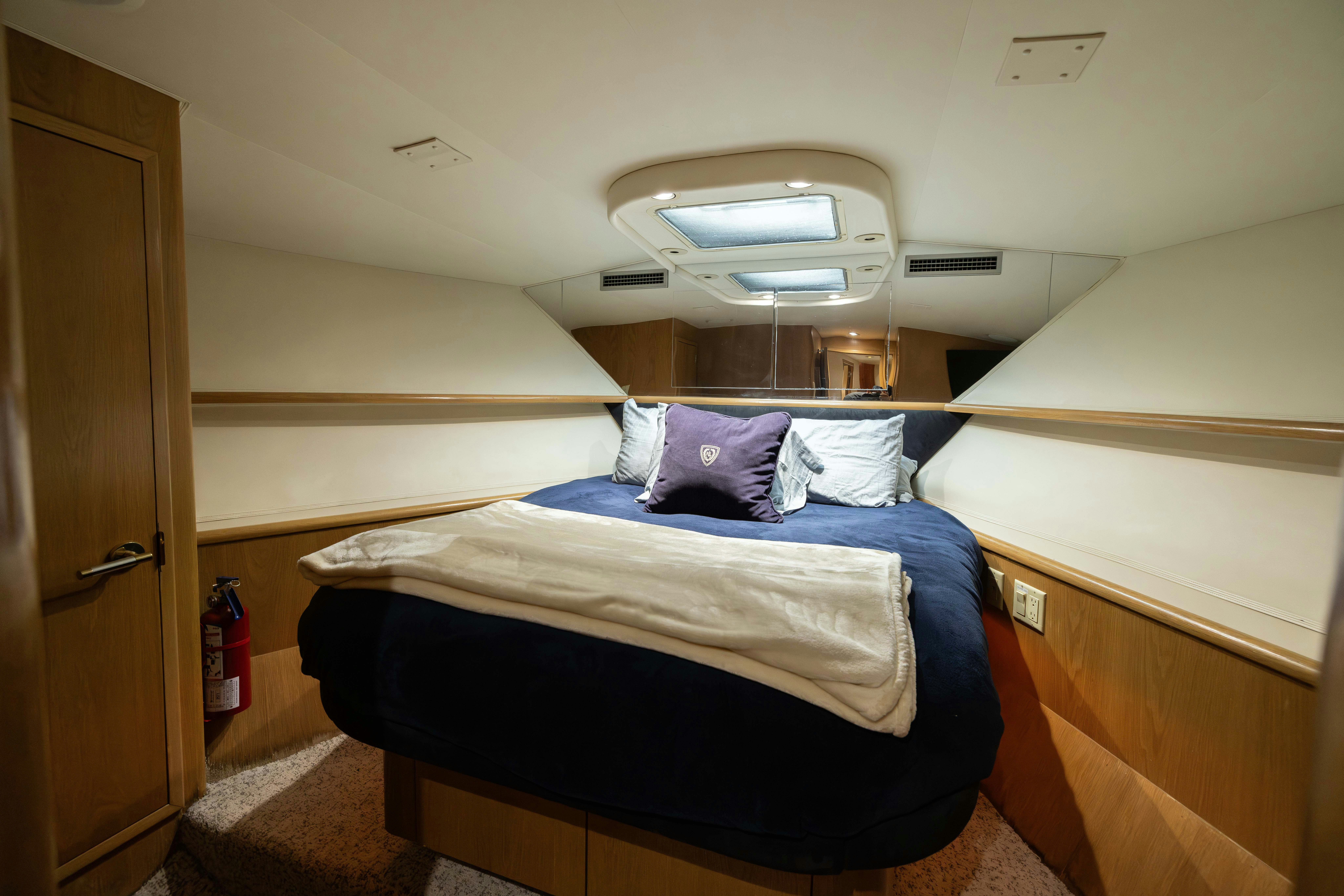a room with a bed and a ceiling fan aboard PREMIUM Yacht for Sale