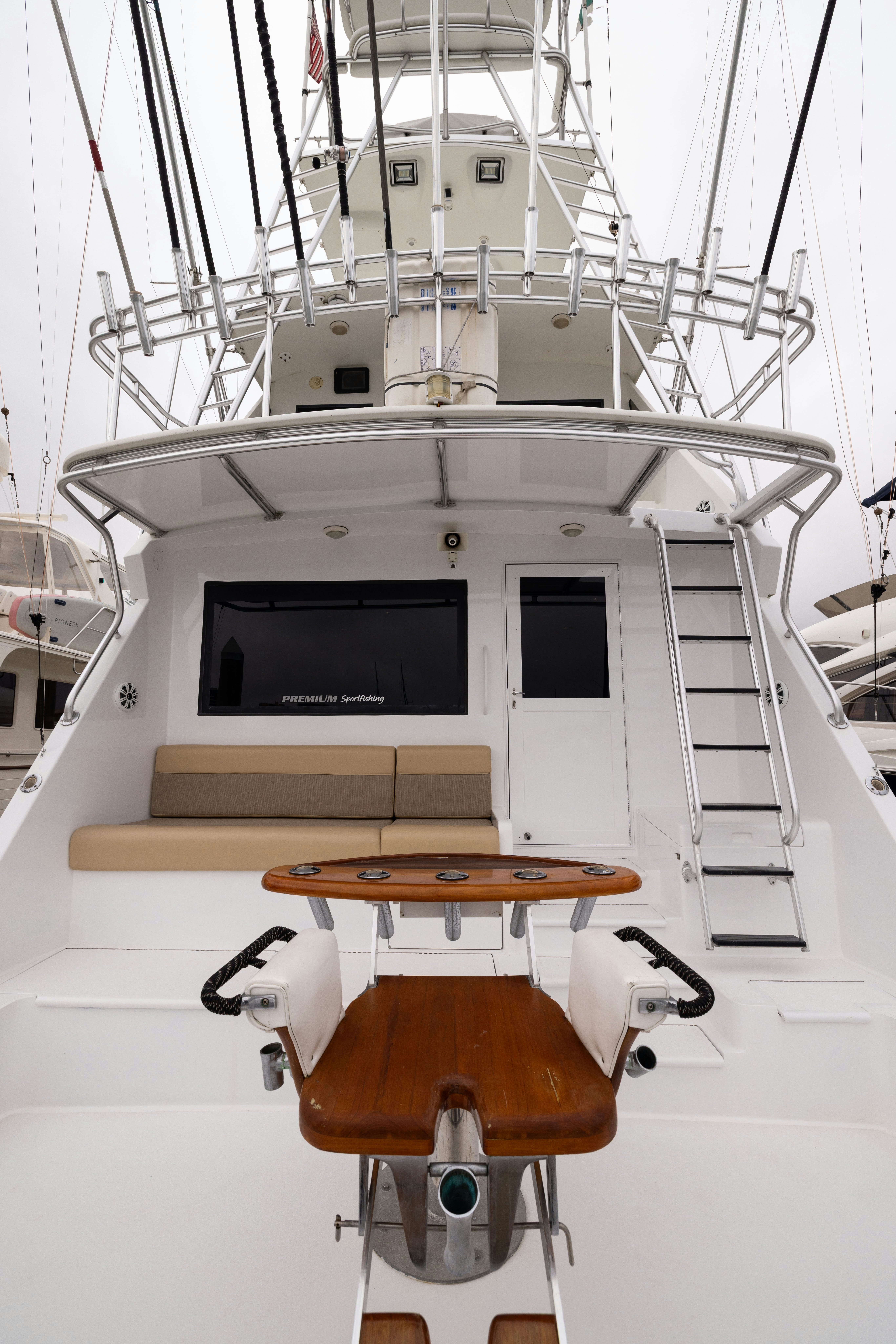 a boat with a screen and a table on it aboard PREMIUM Yacht for Sale