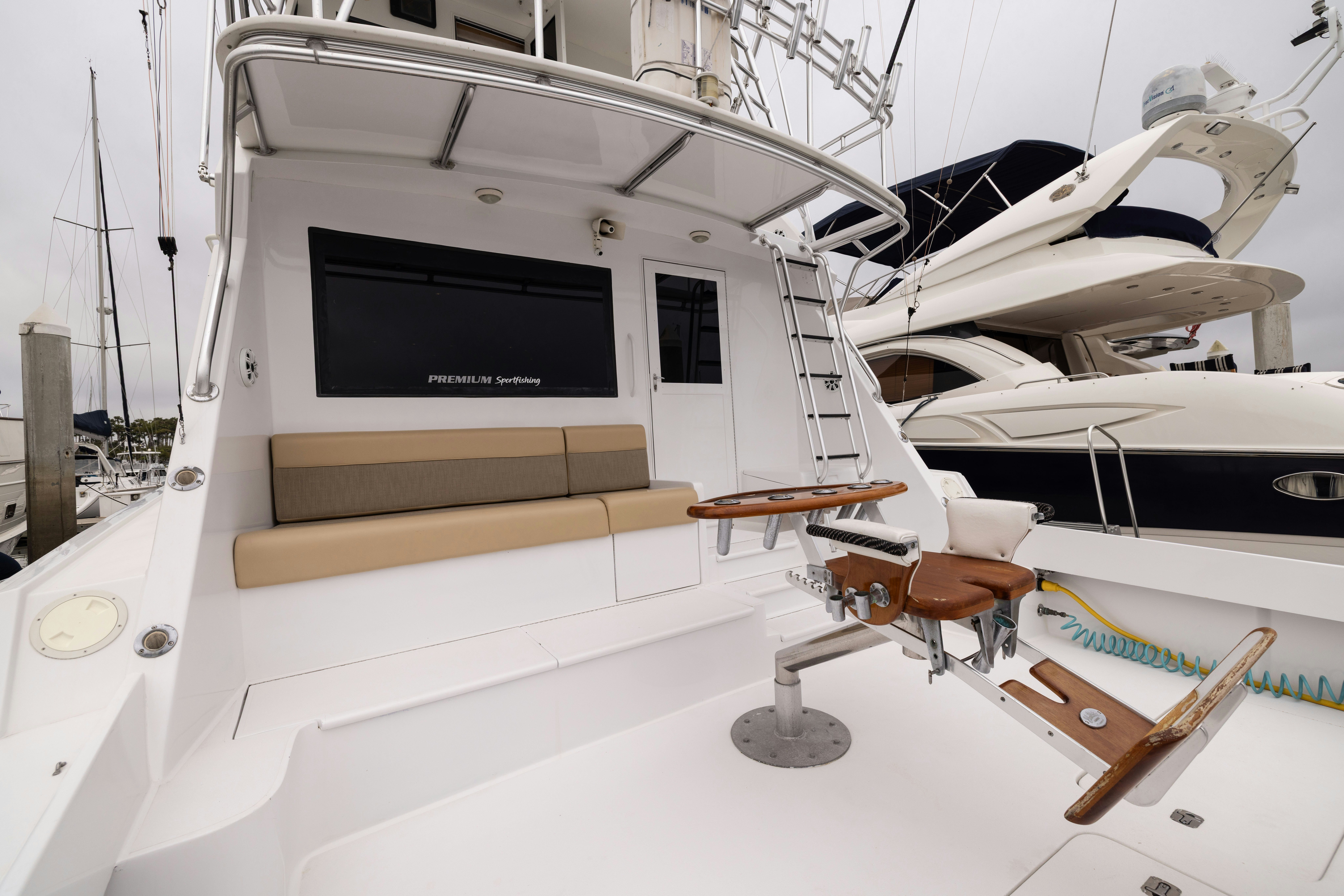 a white boat with a black screen aboard PREMIUM Yacht for Sale