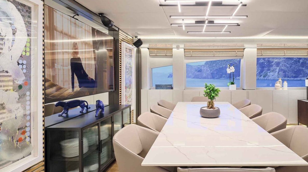 a room with a table and chairs aboard MAMMA MIA Yacht for Charter