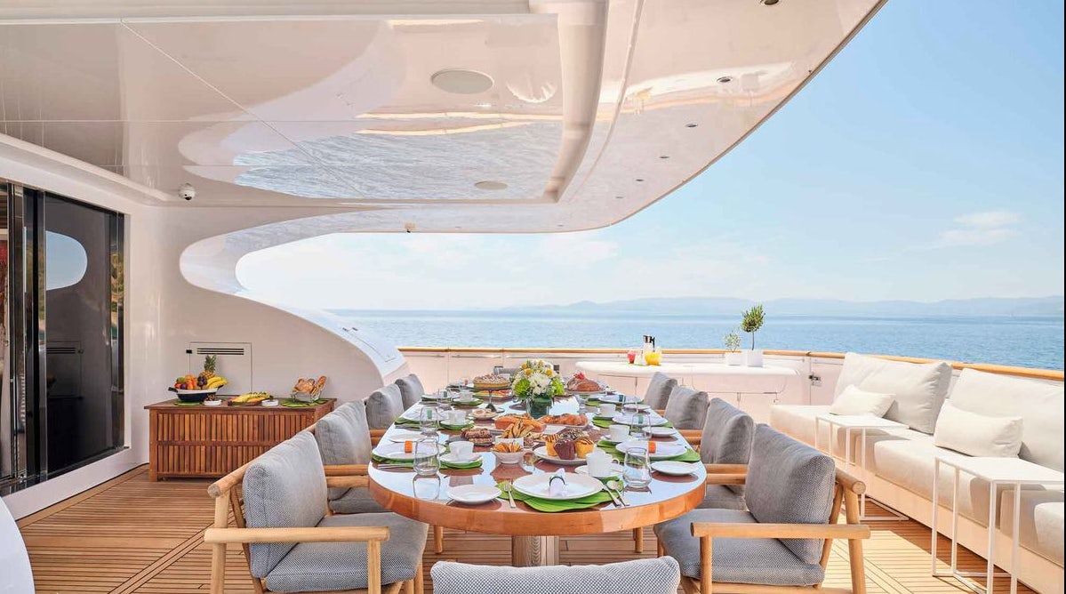a room with a table and chairs aboard MAMMA MIA Yacht for Charter