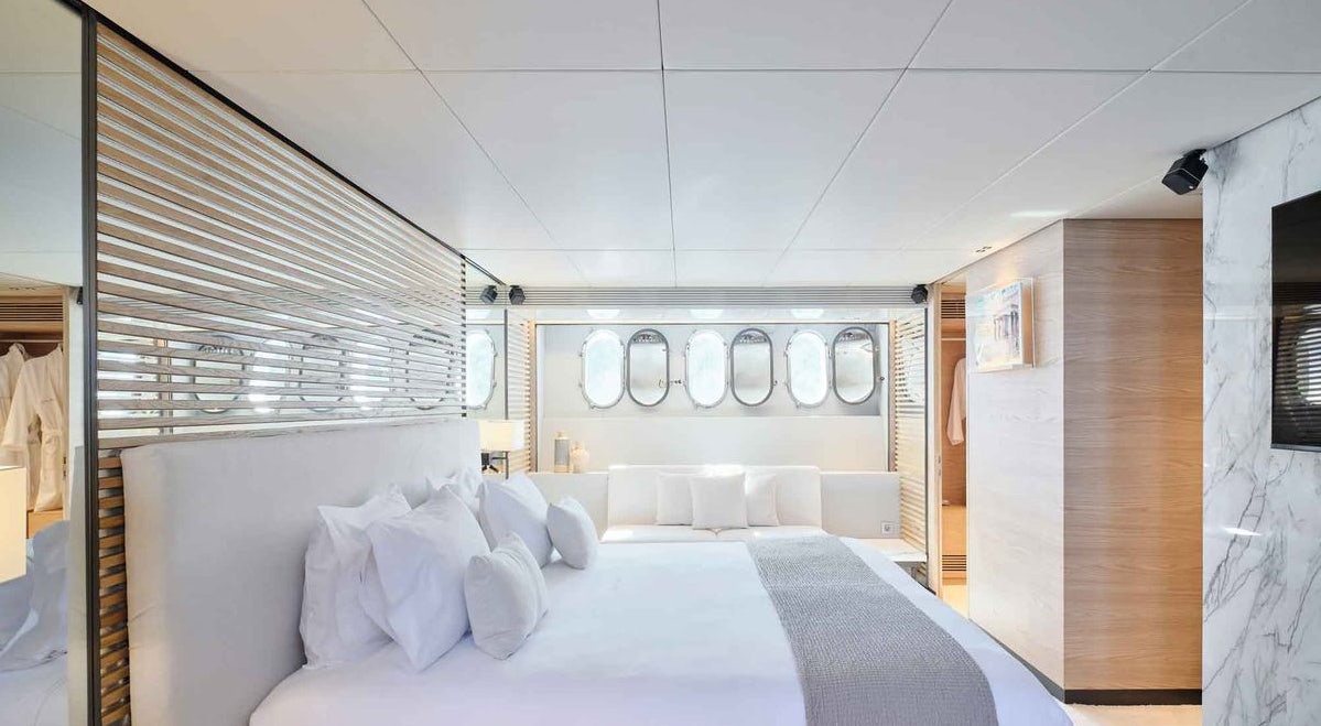 a room with a bed and a mirror aboard MAMMA MIA Yacht for Charter
