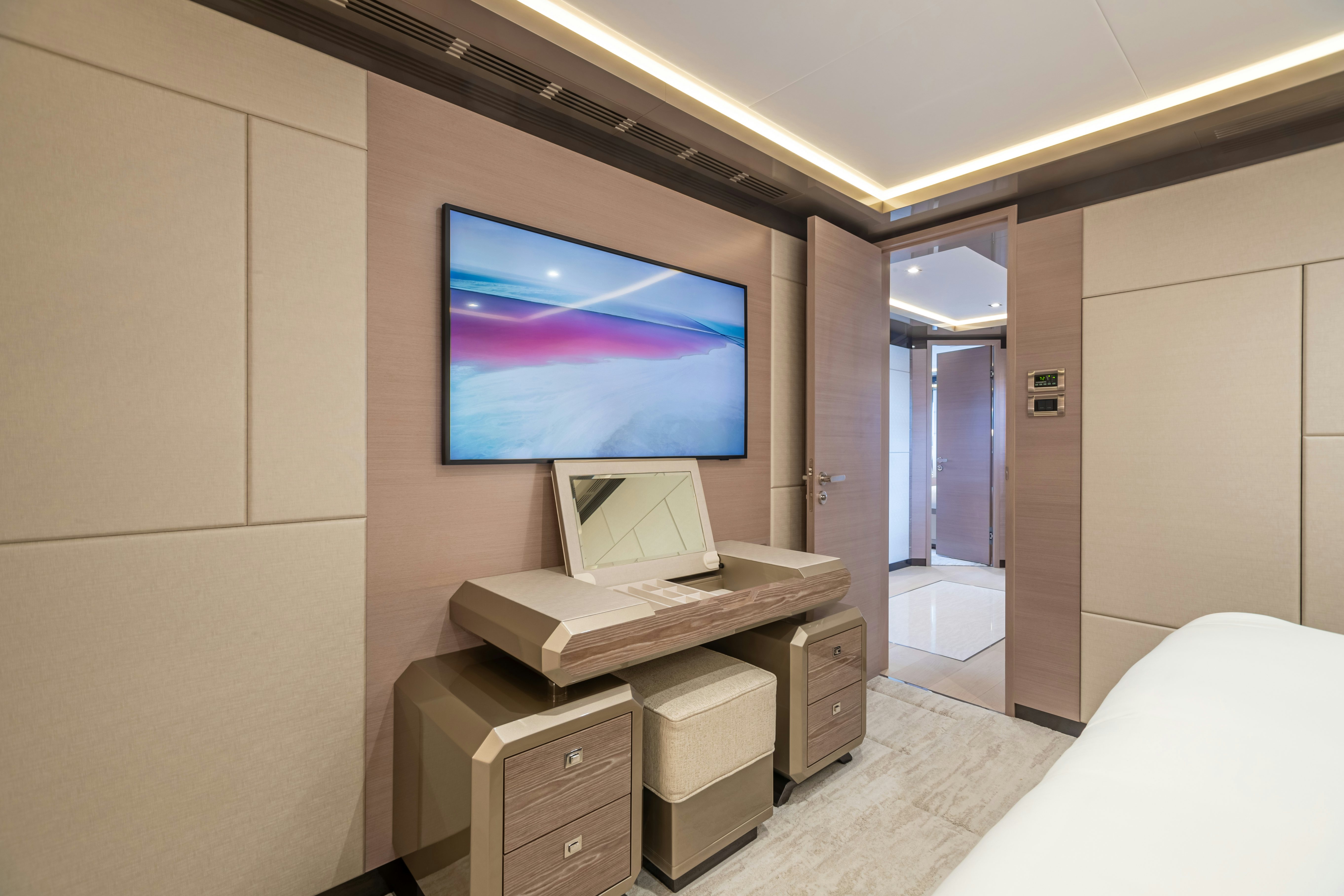 a room with a bed and a television on the wall aboard BOA VIDA Yacht for Charter