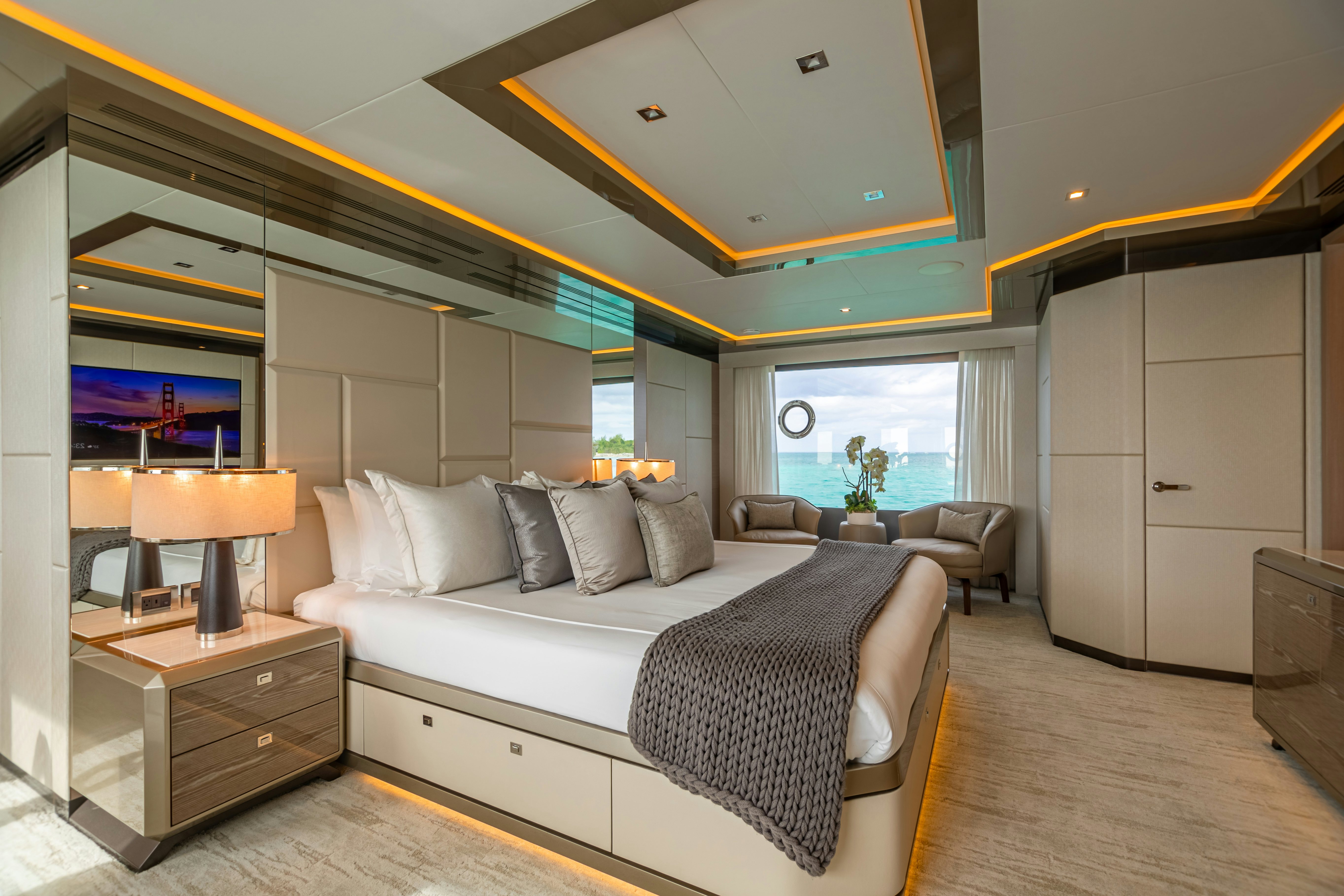 a bedroom with a bed and a tv aboard BOA VIDA Yacht for Charter