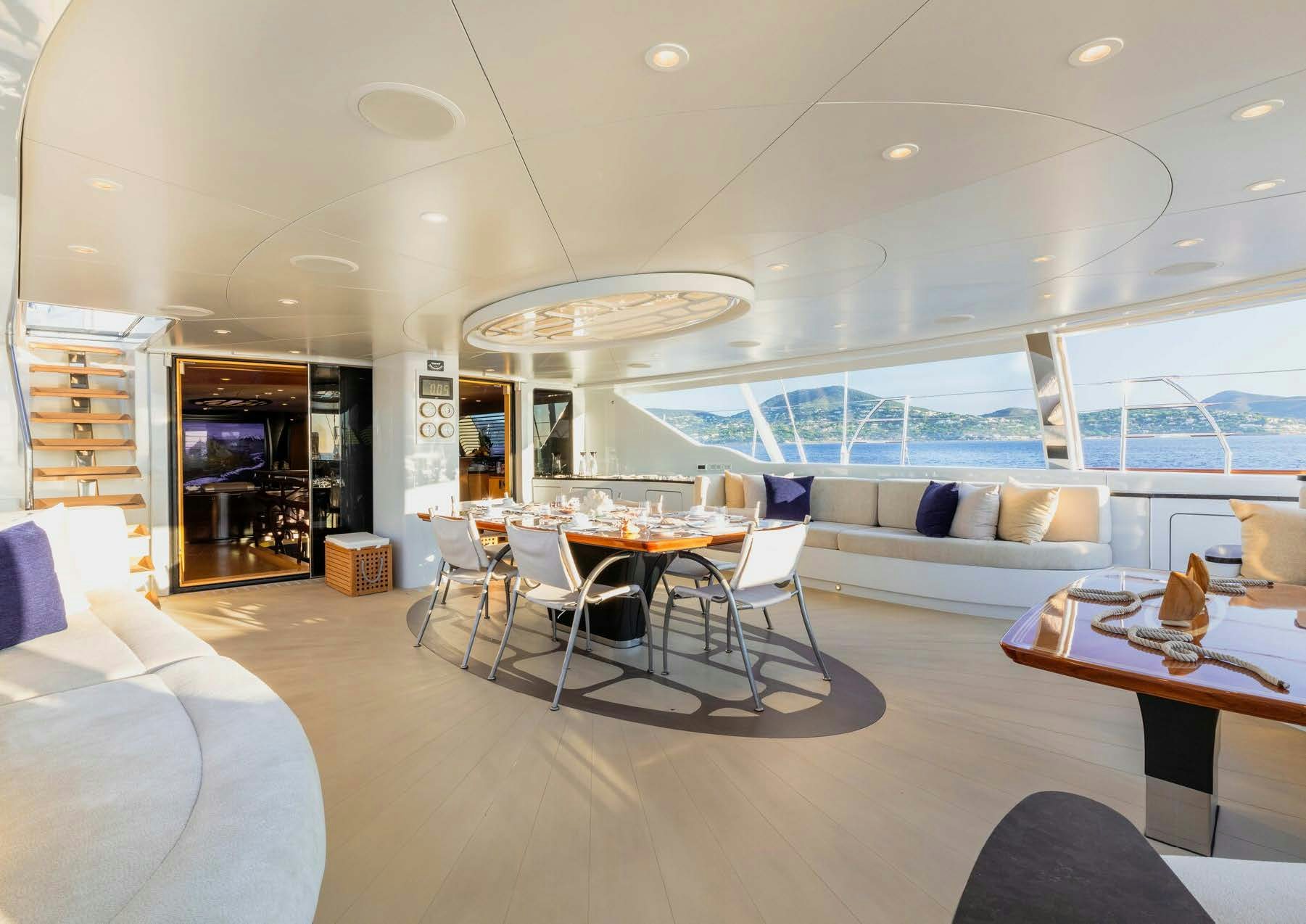 a room with a couch and a table and chairs aboard SALVAJE Yacht for Sale