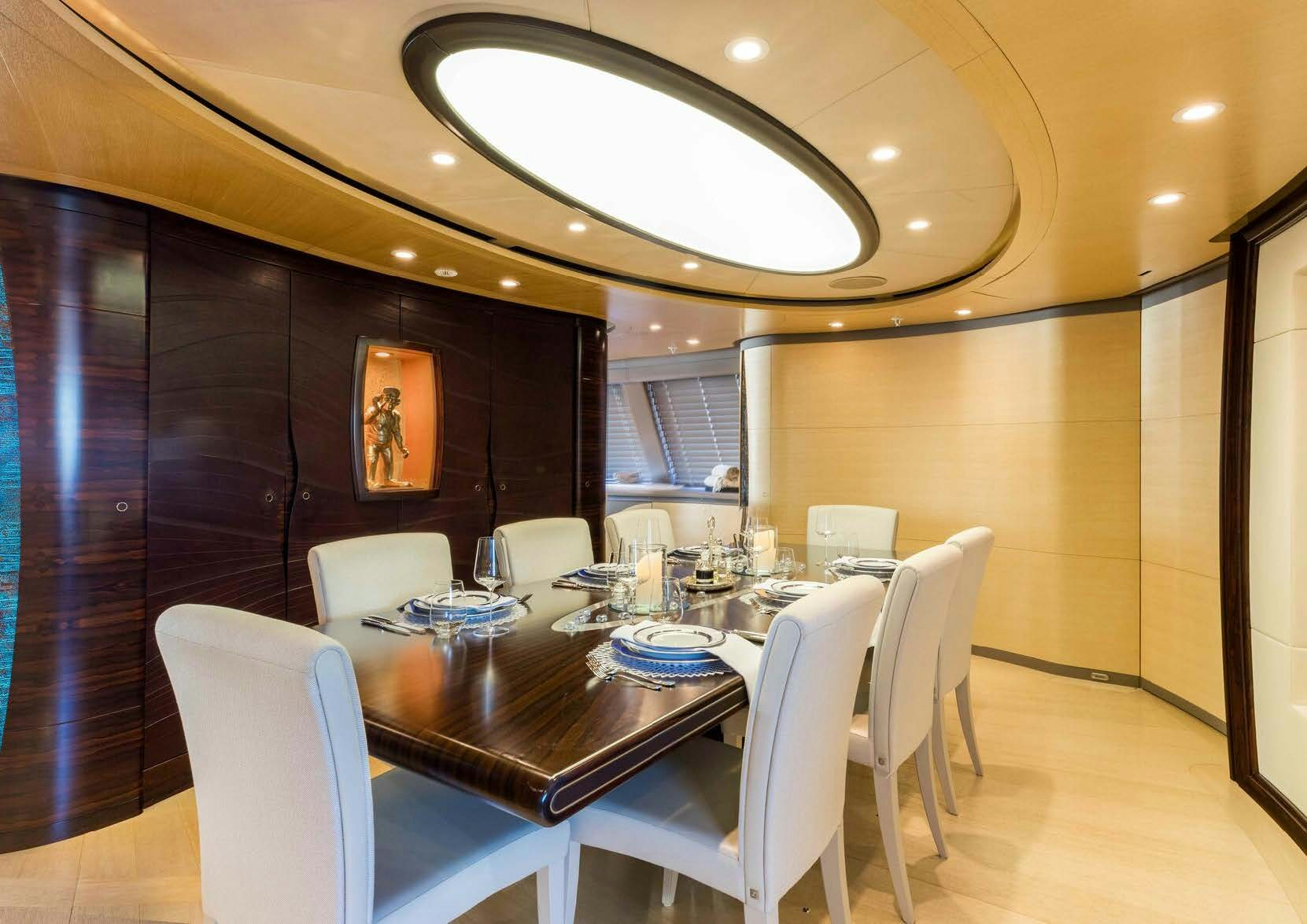 a dining room with a table and chairs aboard SALVAJE Yacht for Sale