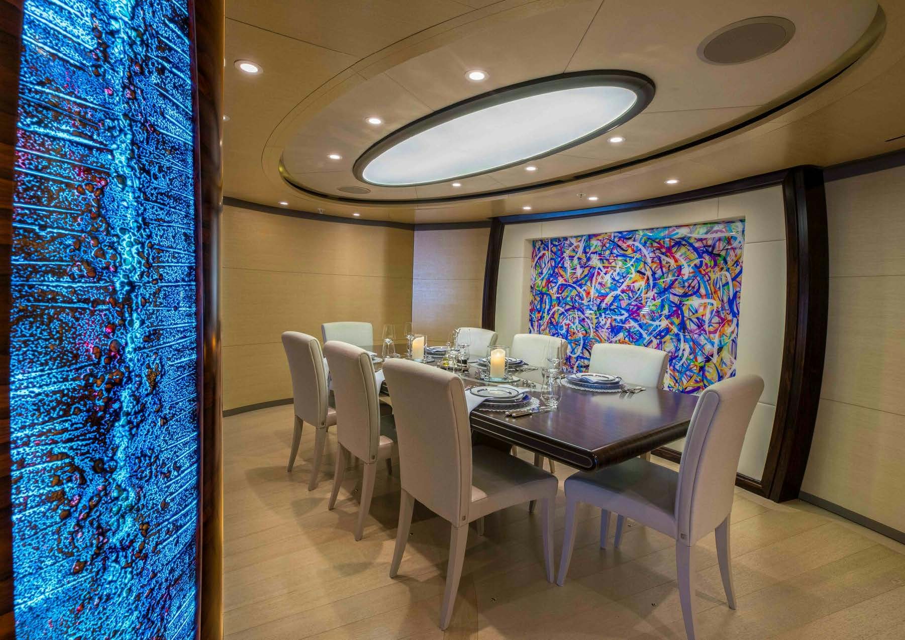a dining room with a table and chairs aboard SALVAJE Yacht for Sale