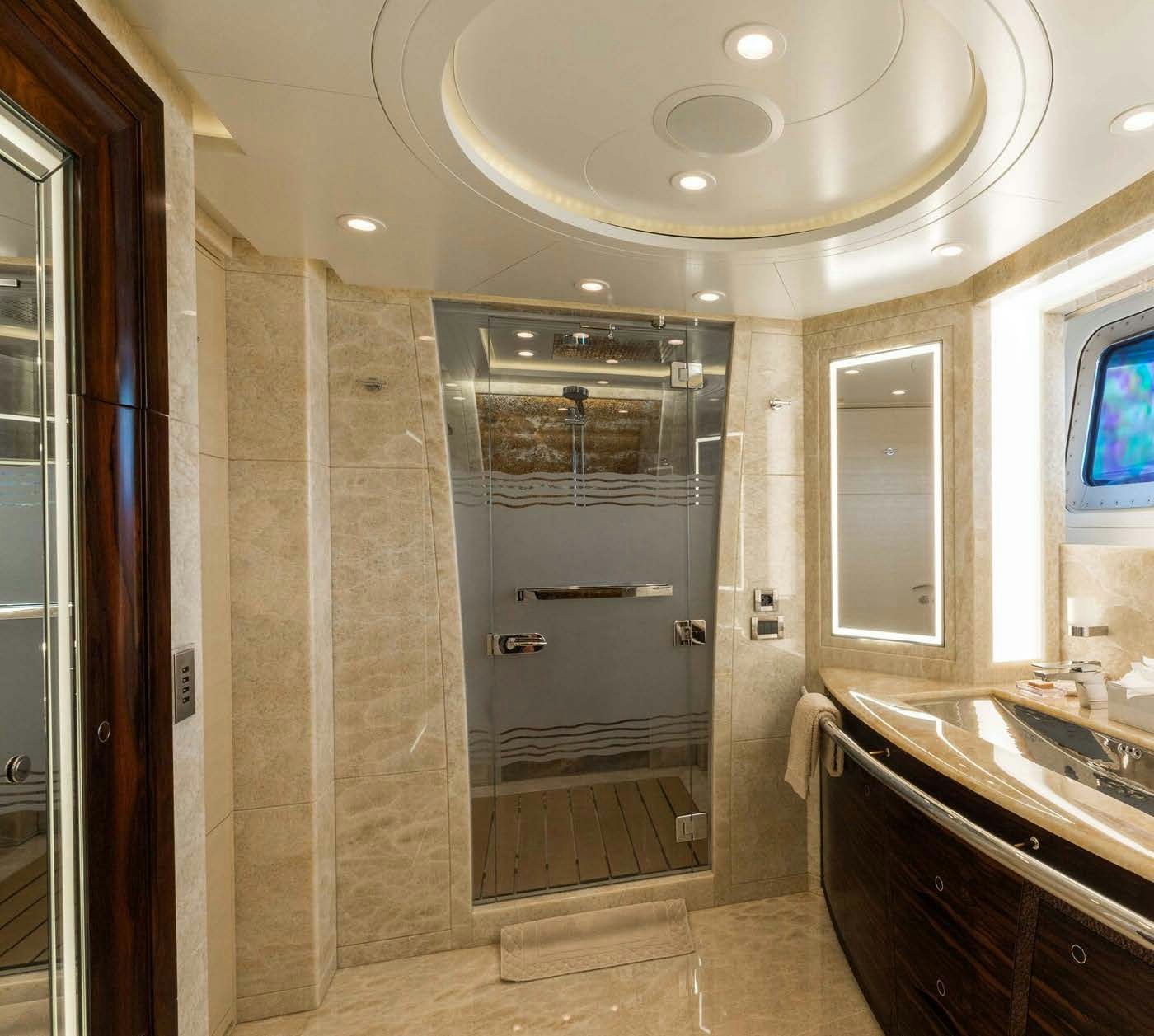 a bathroom with a glass shower aboard SALVAJE Yacht for Sale