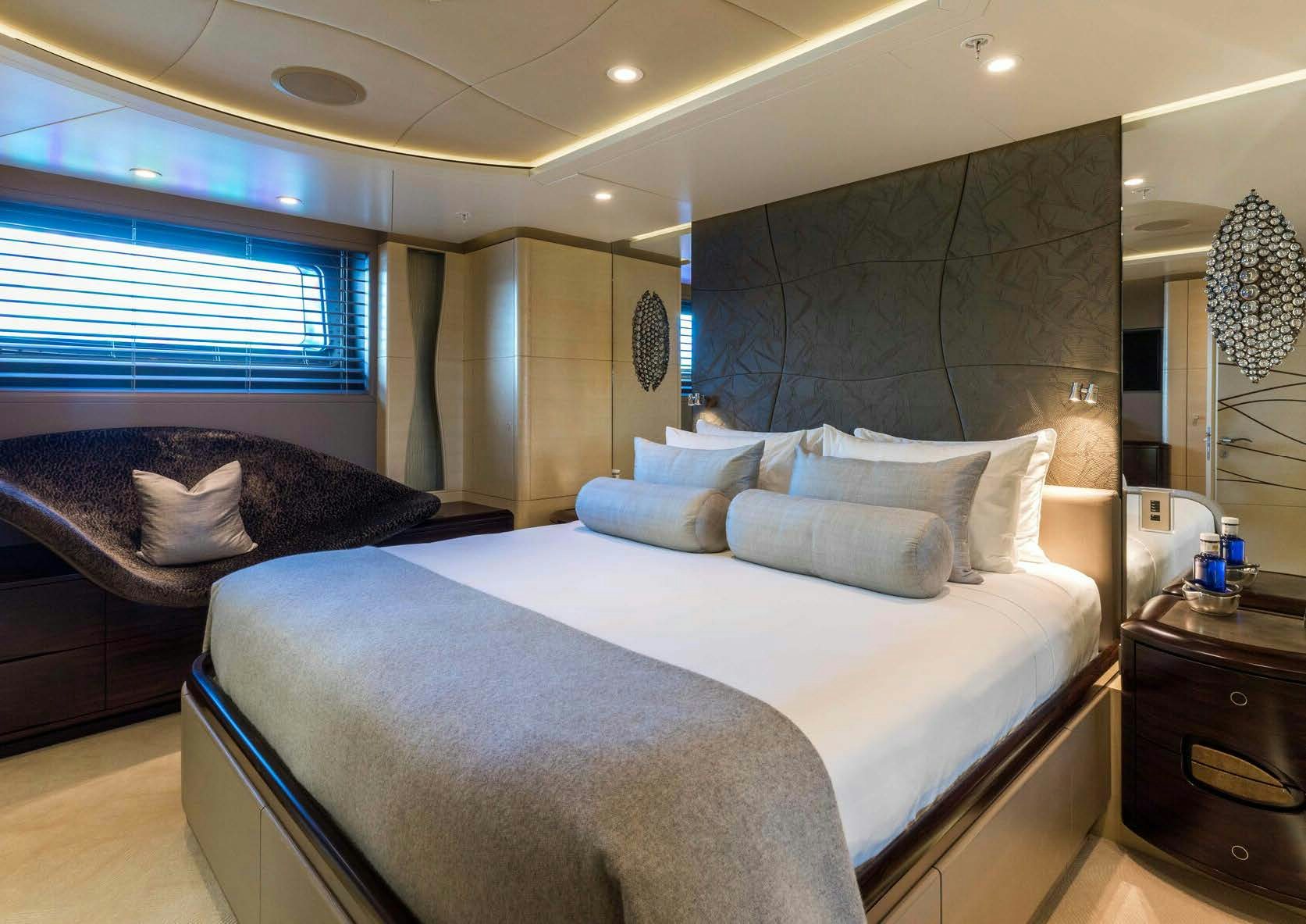 a large bedroom with a large bed aboard SALVAJE Yacht for Sale