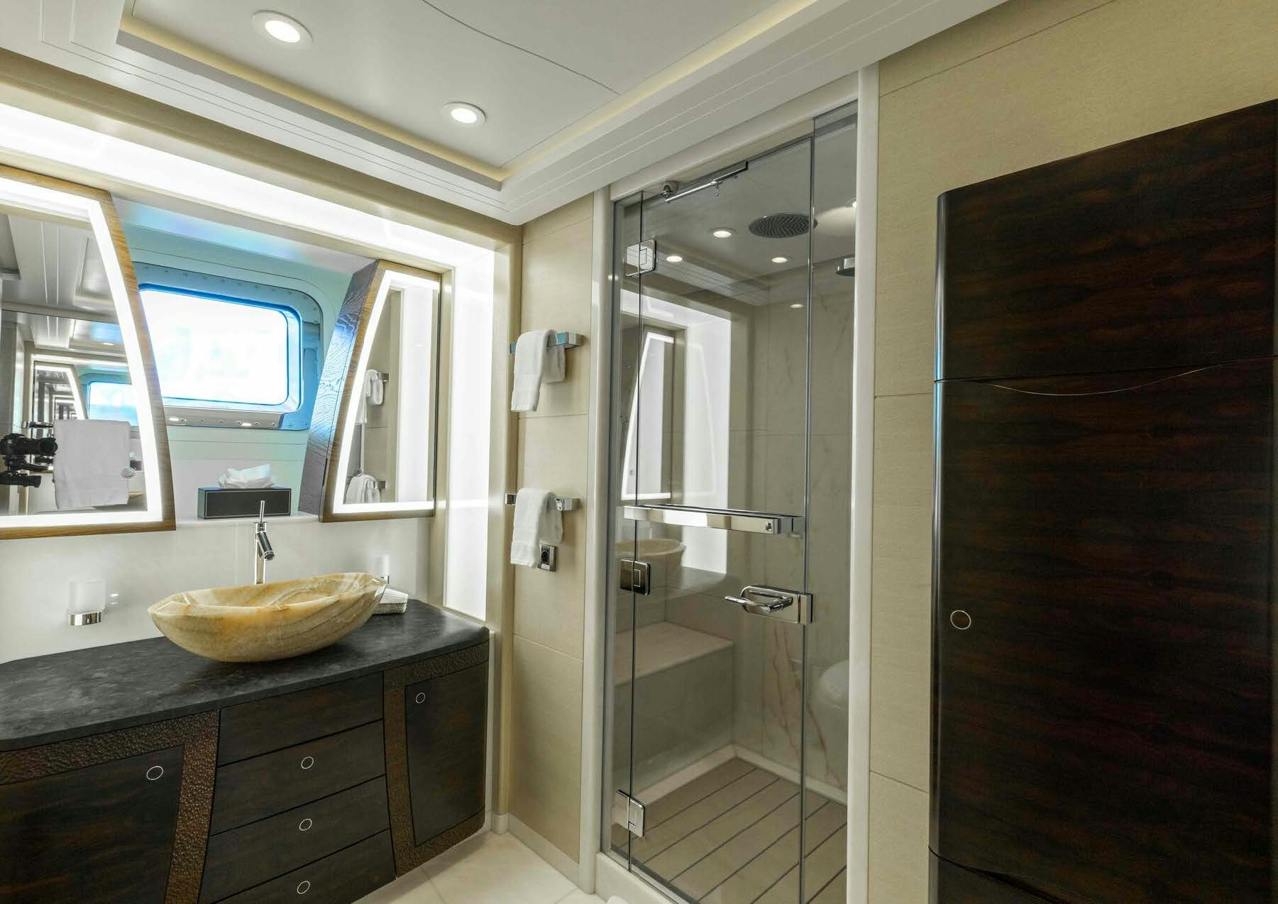 a bathroom with a sink and a shower aboard SALVAJE Yacht for Sale
