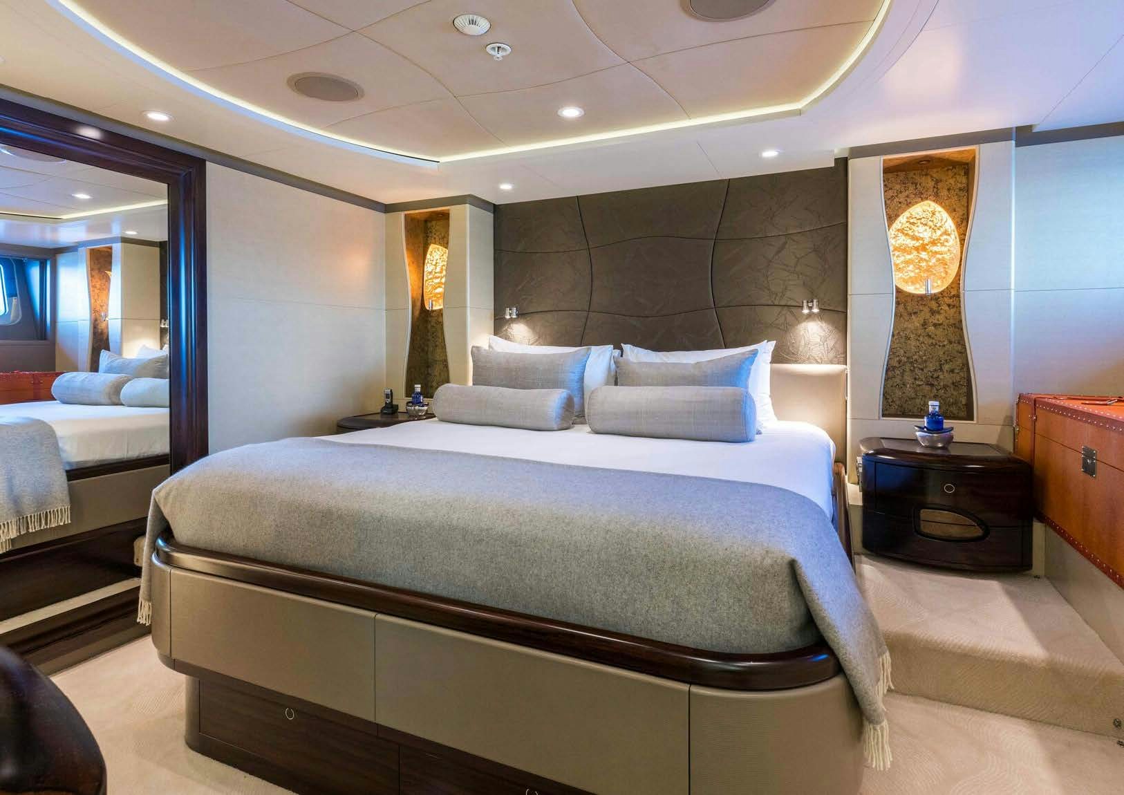 a large bedroom with a large bed aboard SALVAJE Yacht for Sale