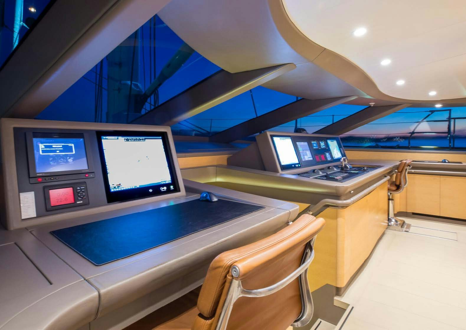 a room with computers and monitors aboard SALVAJE Yacht for Sale