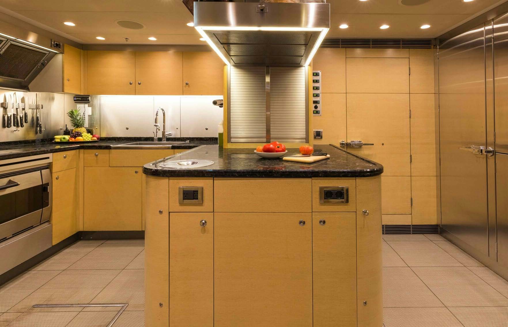 a kitchen with a large island aboard SALVAJE Yacht for Sale