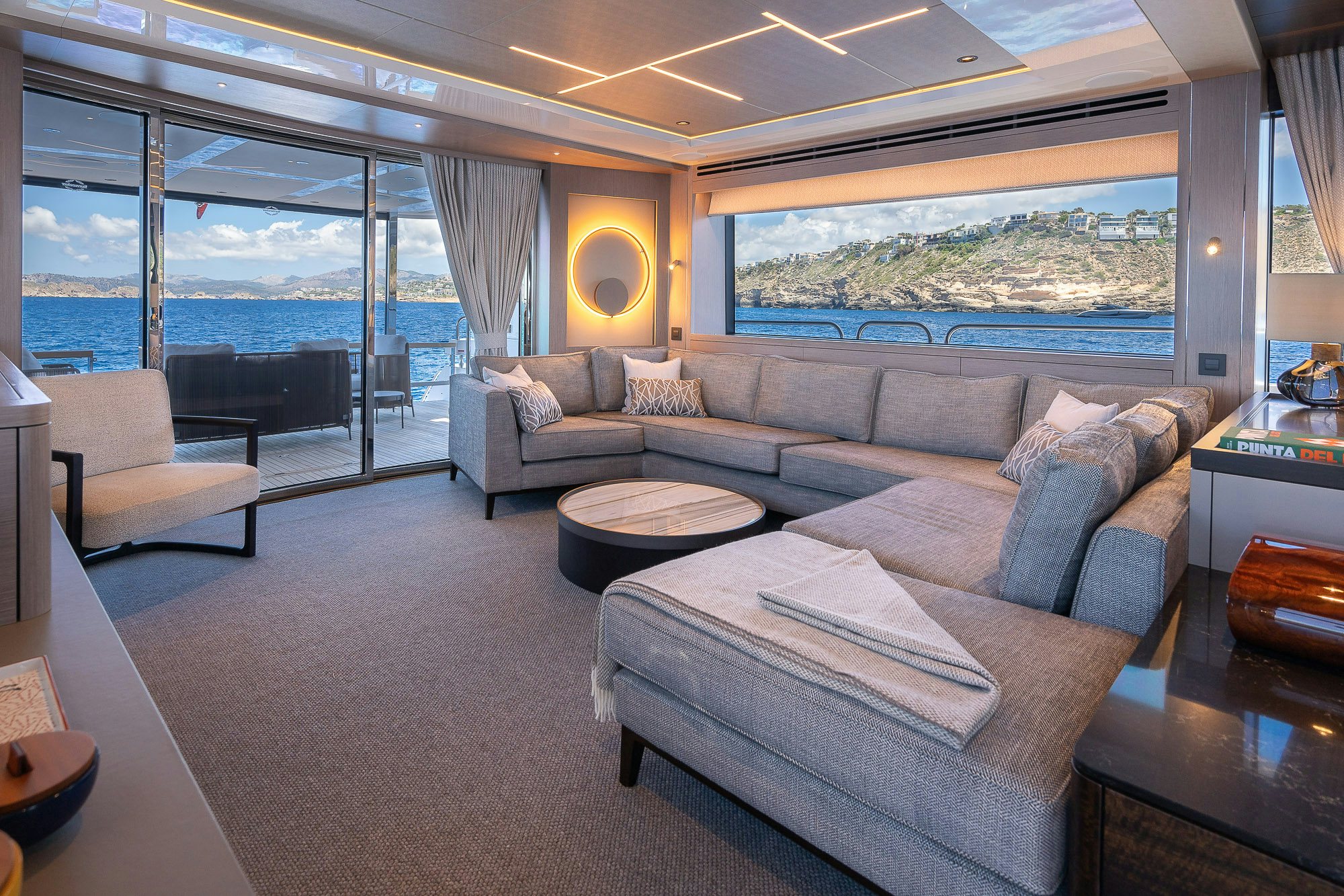 a living room with a large window aboard CELESTE NOREEN Yacht for Sale