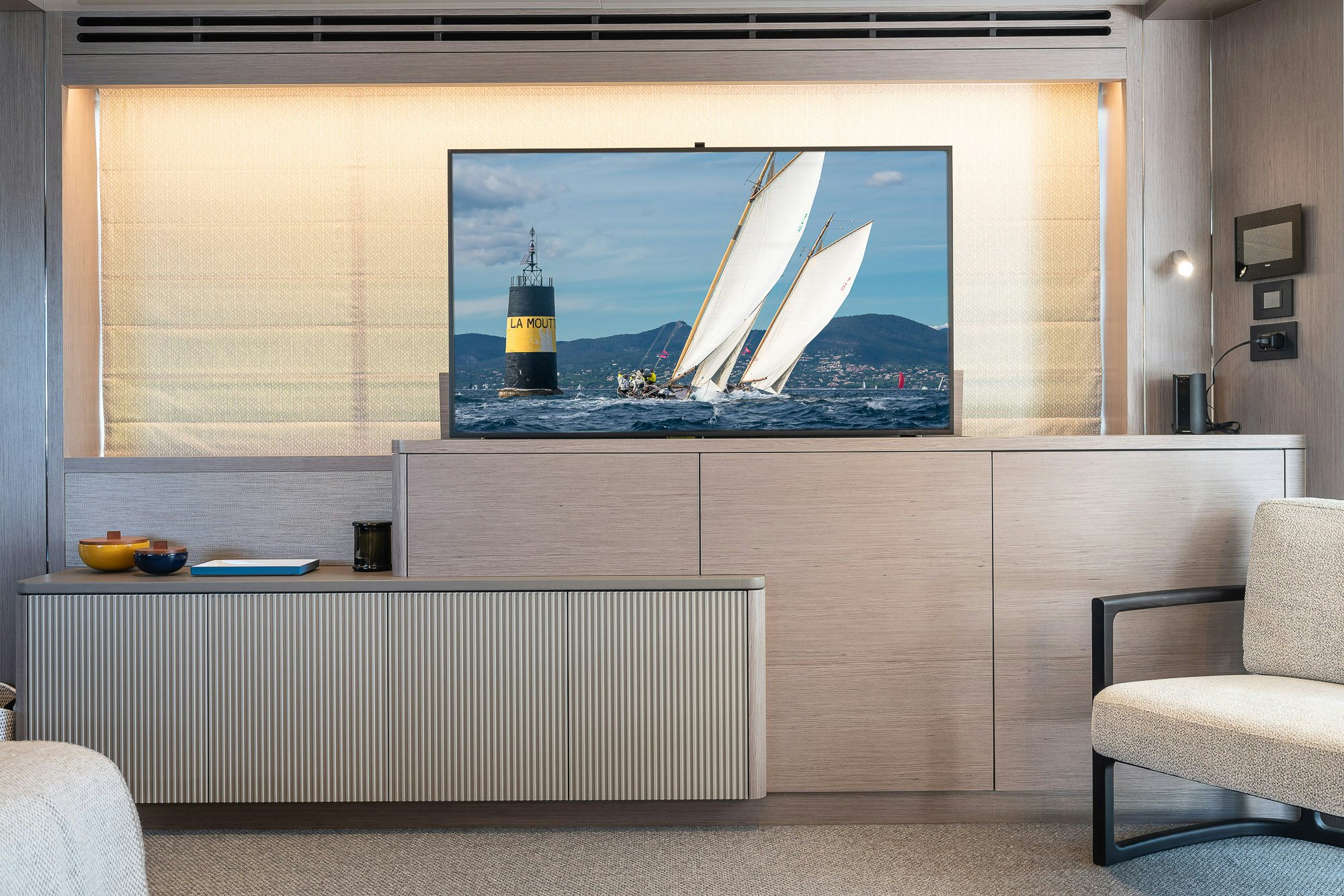 a room with a couch and a tv on the wall aboard CELESTE NOREEN Yacht for Sale