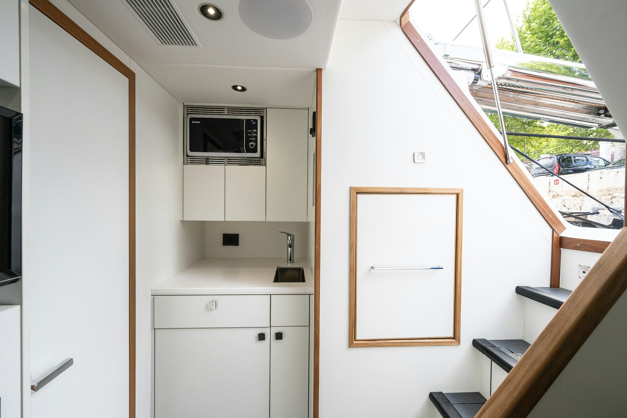 a white kitchen with a sliding door aboard CELESTE NOREEN Yacht for Sale