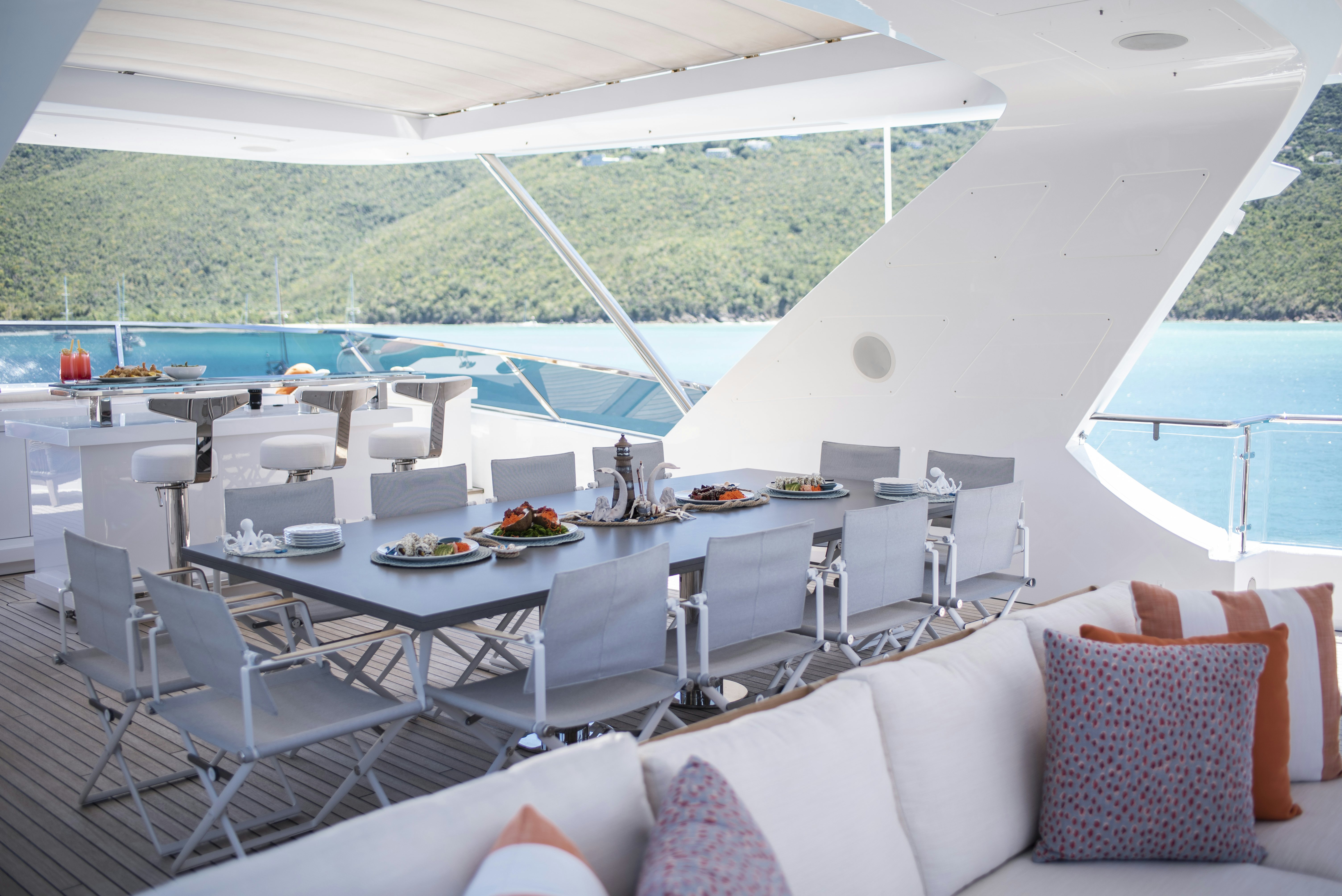 a large white table with chairs around it aboard WABASH Yacht for Sale