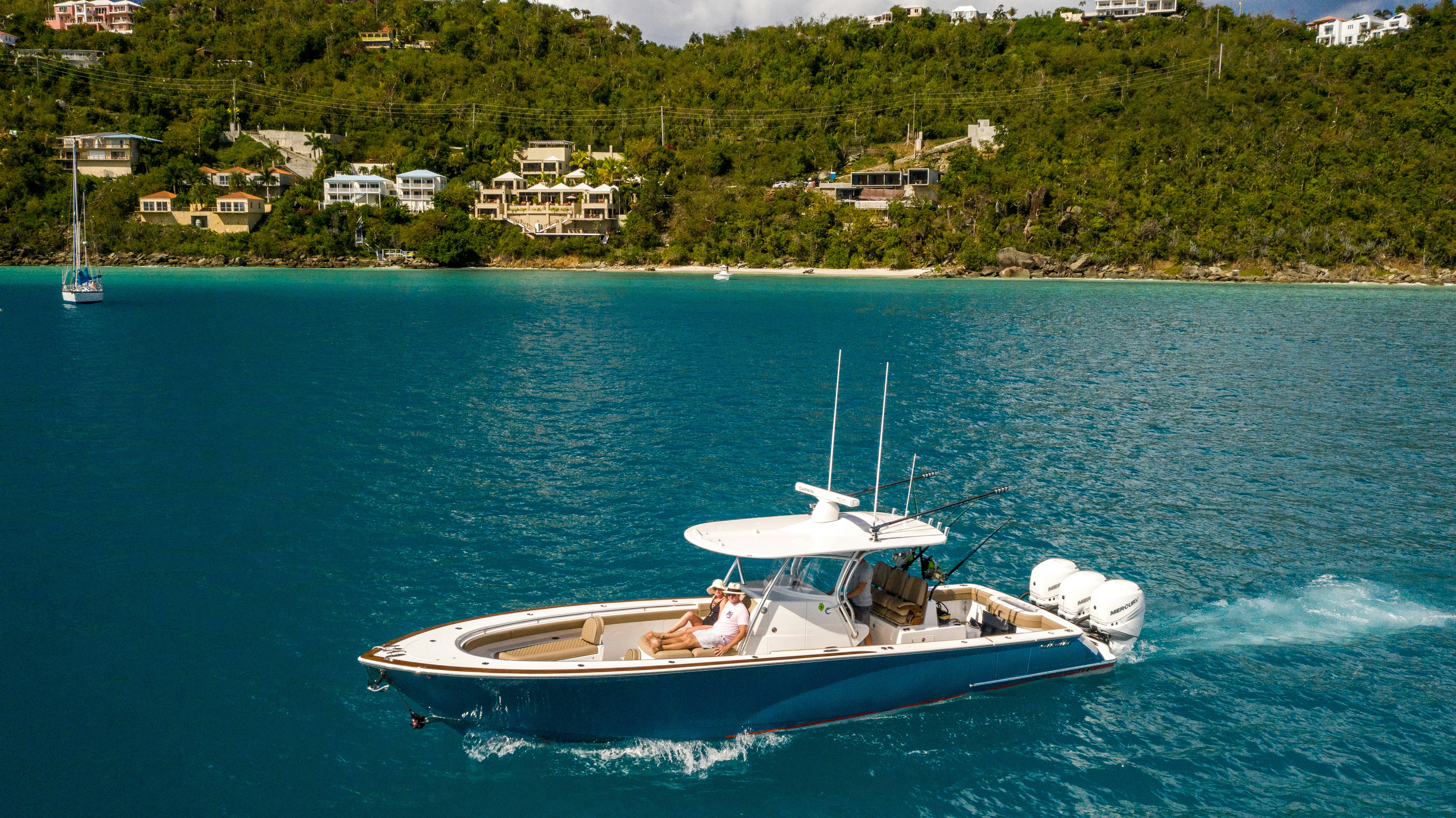 a person driving a boat on the water aboard WABASH Yacht for Sale