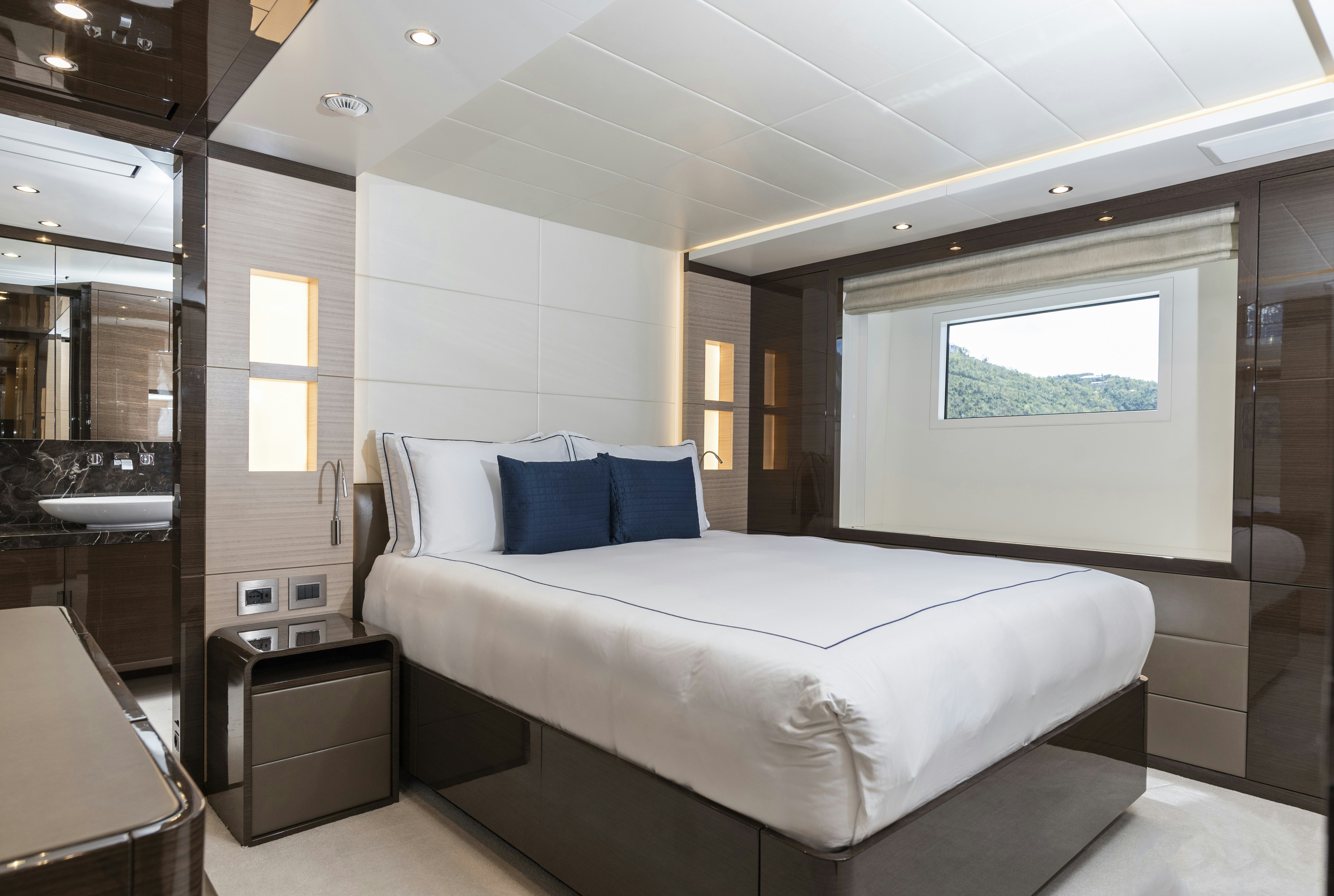 a large white bed in a room aboard WABASH Yacht for Sale