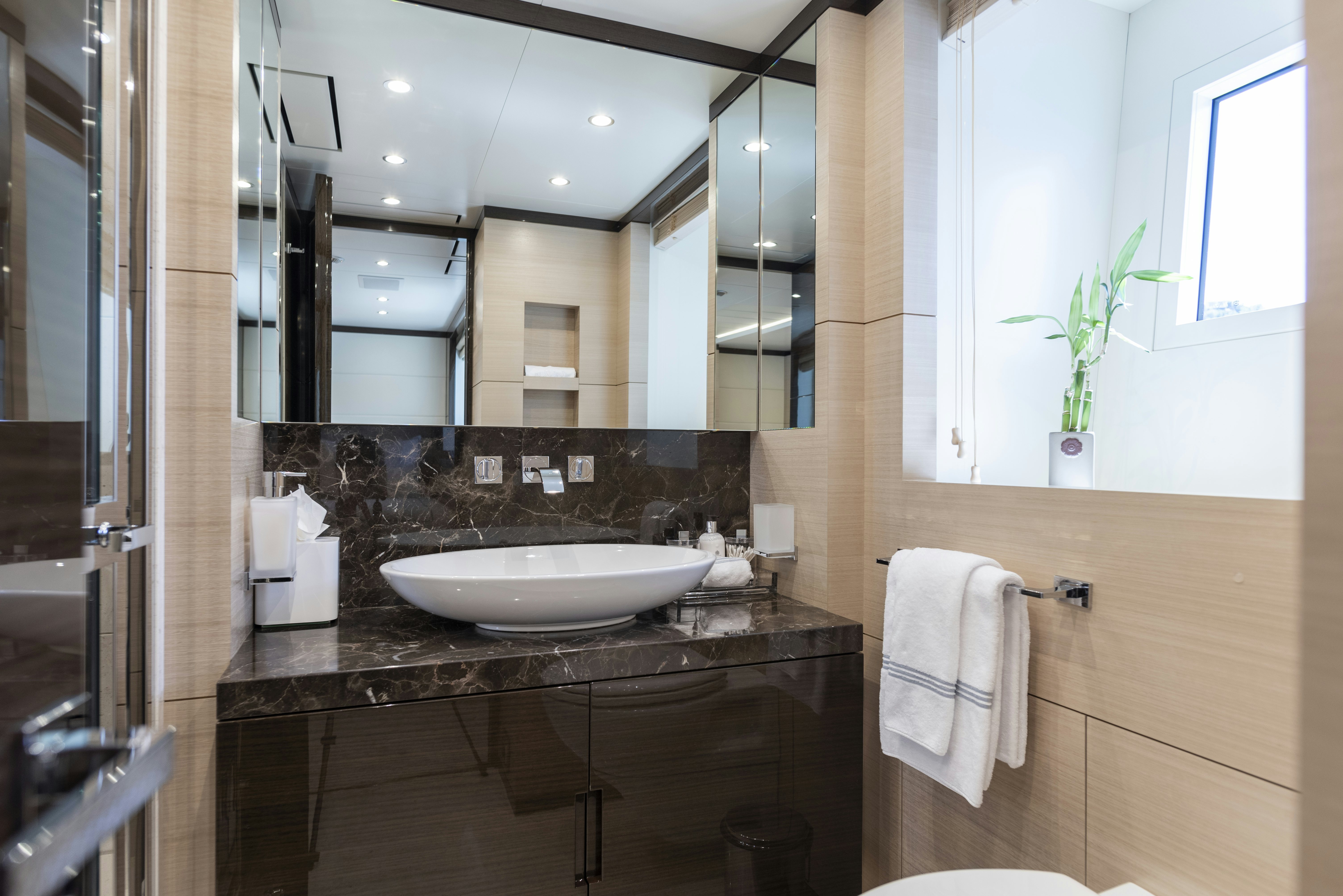 a bathroom with a sink and mirror aboard WABASH Yacht for Sale