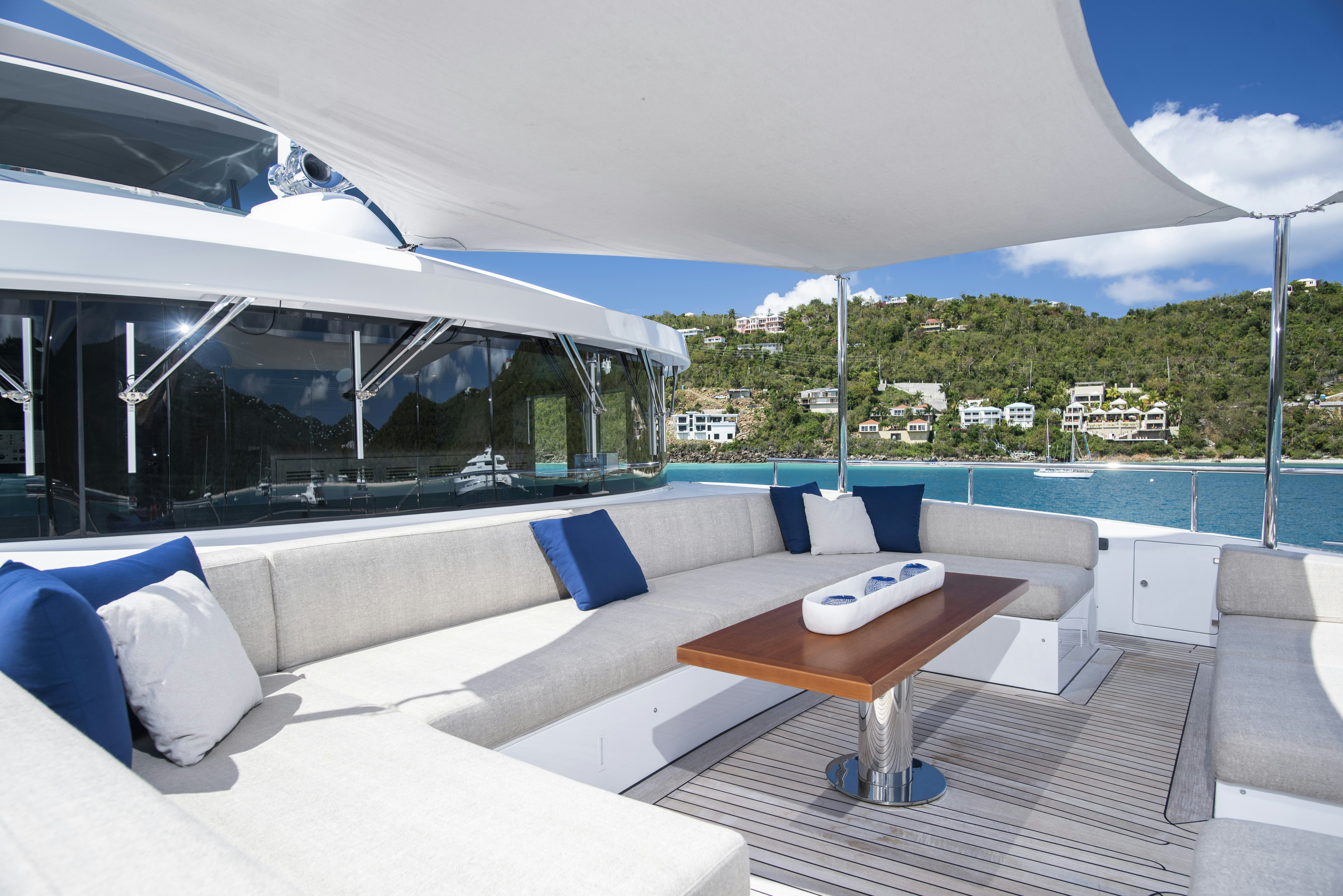 a room with a couch and a table and a pool aboard WABASH Yacht for Sale