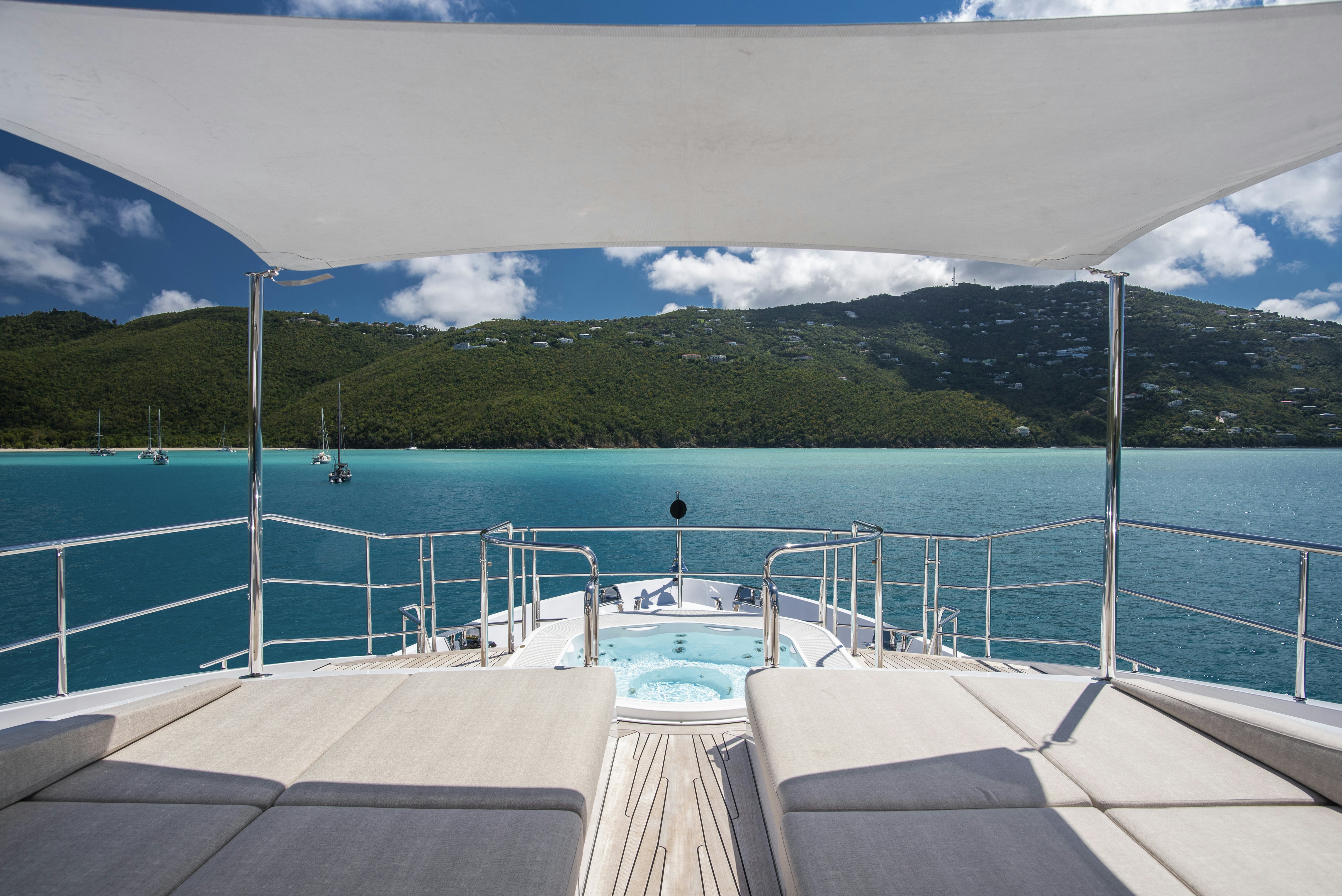 a dock with a pool and trees in the background aboard WABASH Yacht for Sale