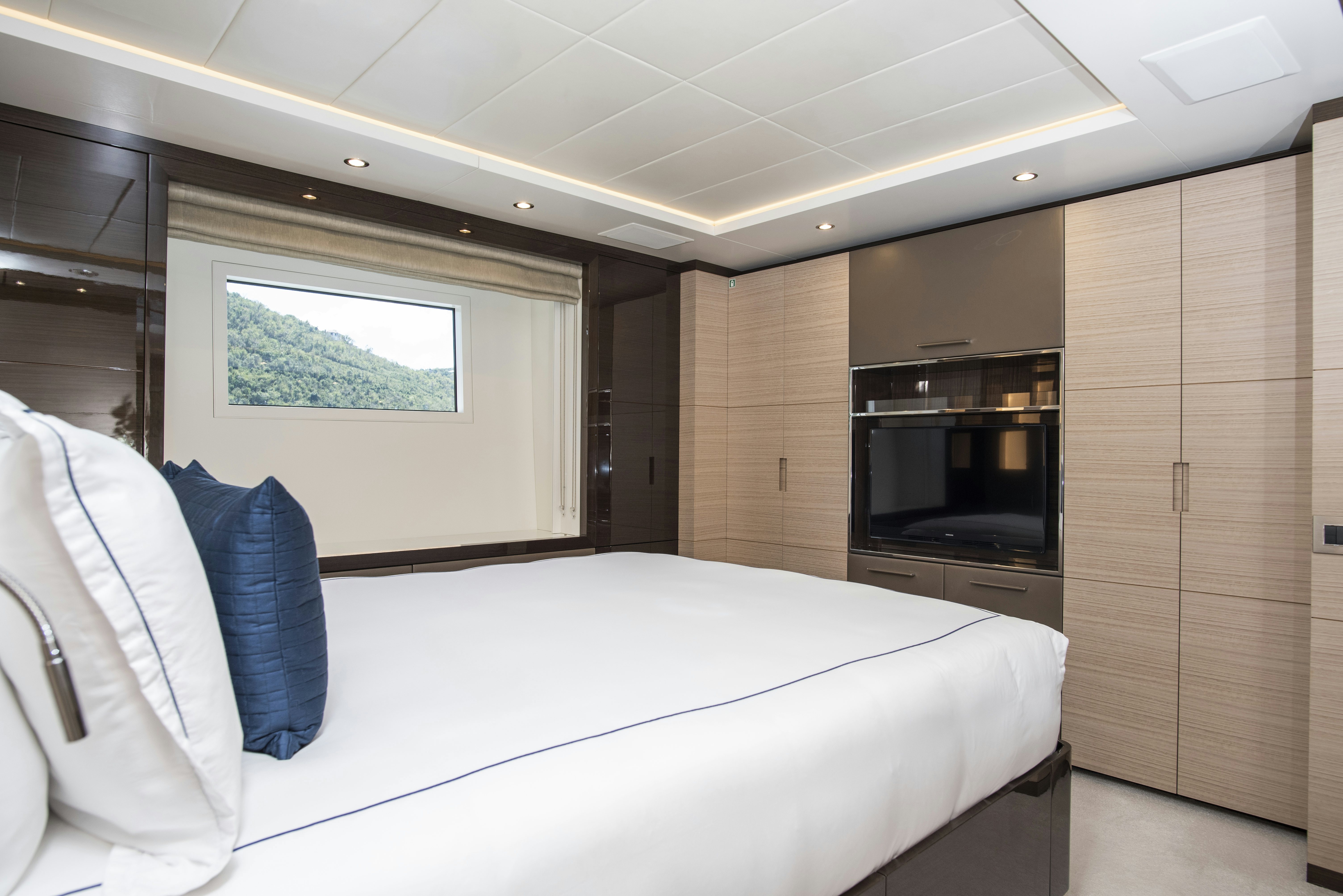 a room with a bed and a television aboard WABASH Yacht for Sale