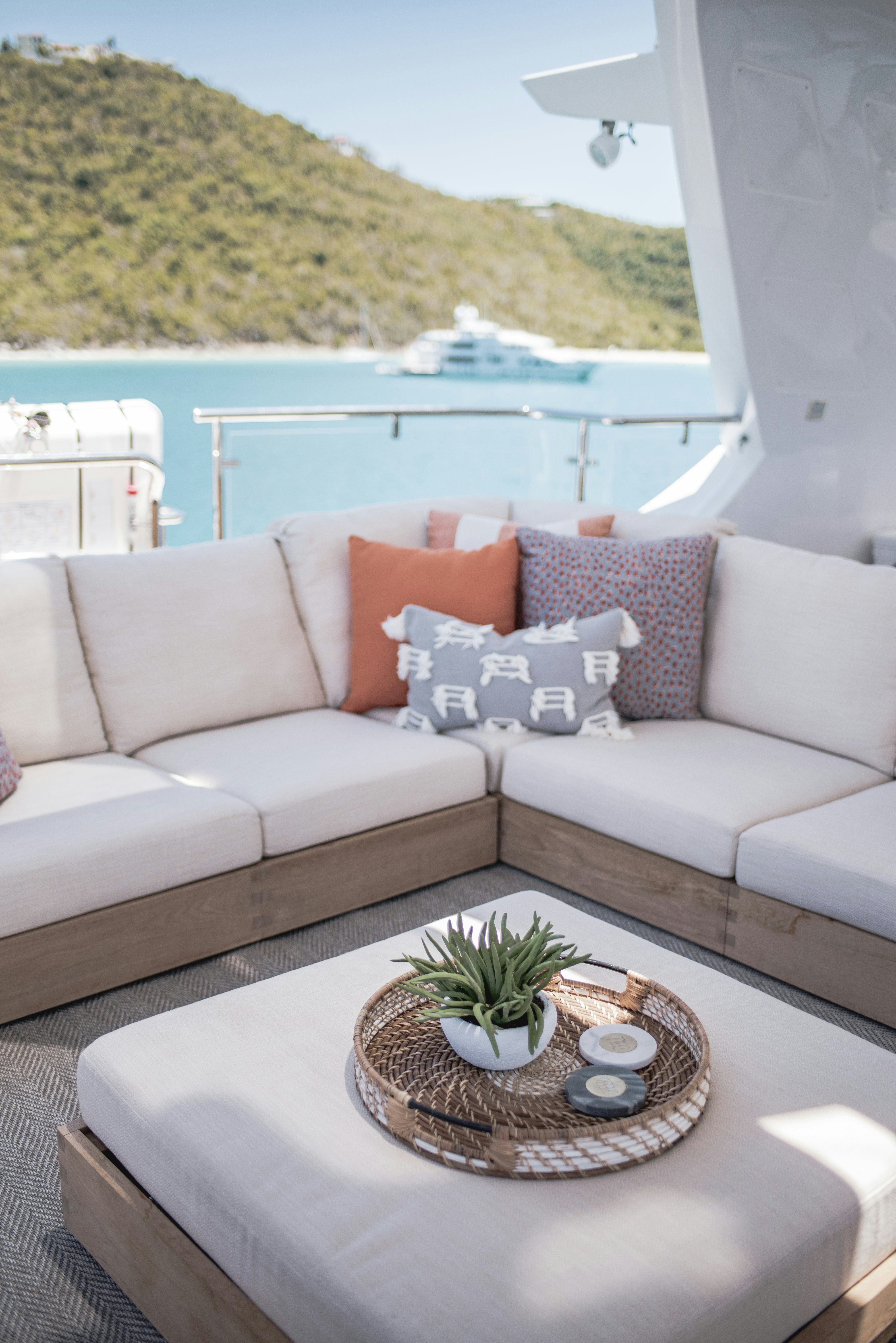 a white couch with a plant on it aboard WABASH Yacht for Sale