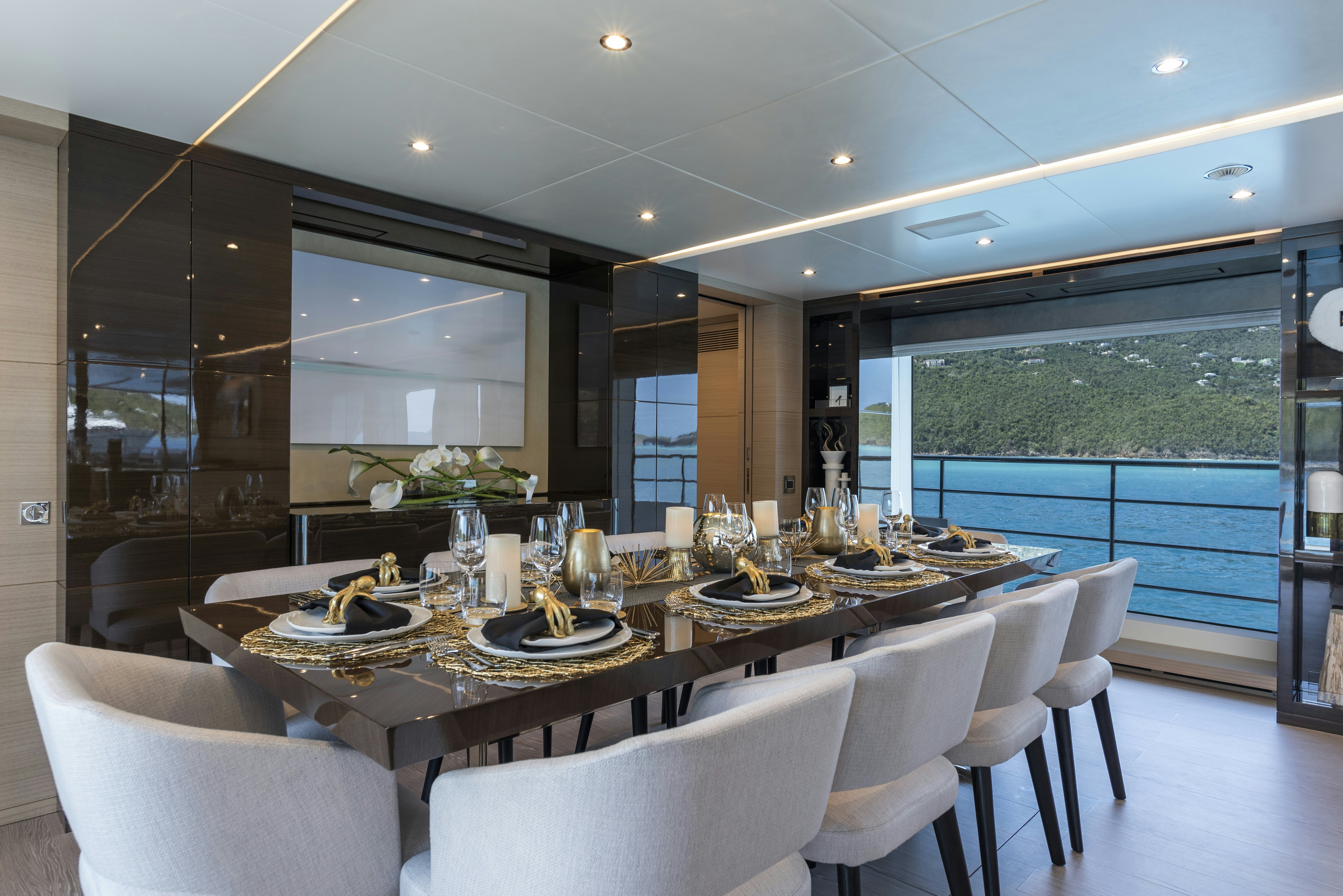 a dining room with a large window aboard WABASH Yacht for Sale