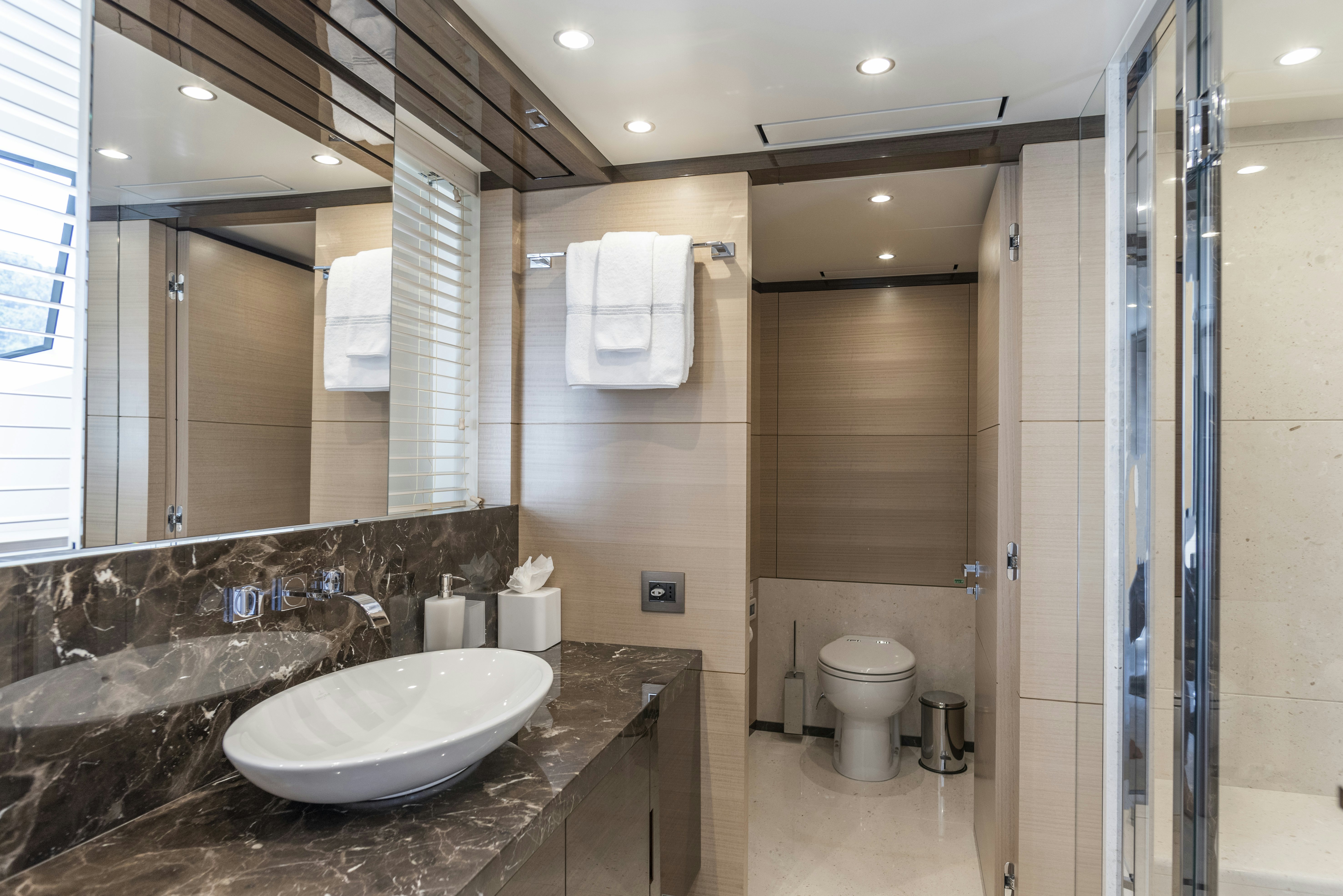 a bathroom with a large marble countertop aboard WABASH Yacht for Sale