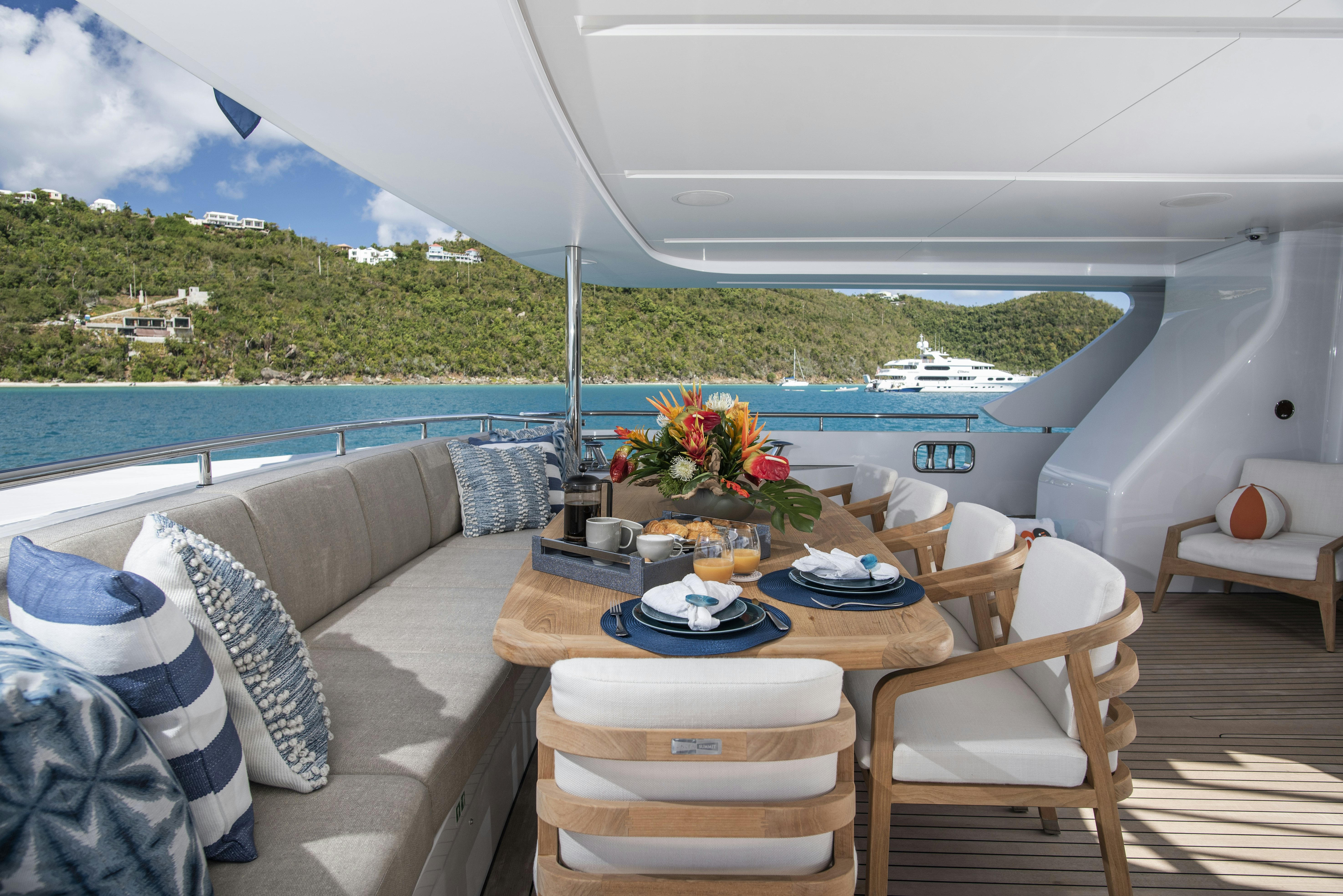 a table and chairs on a deck aboard WABASH Yacht for Sale