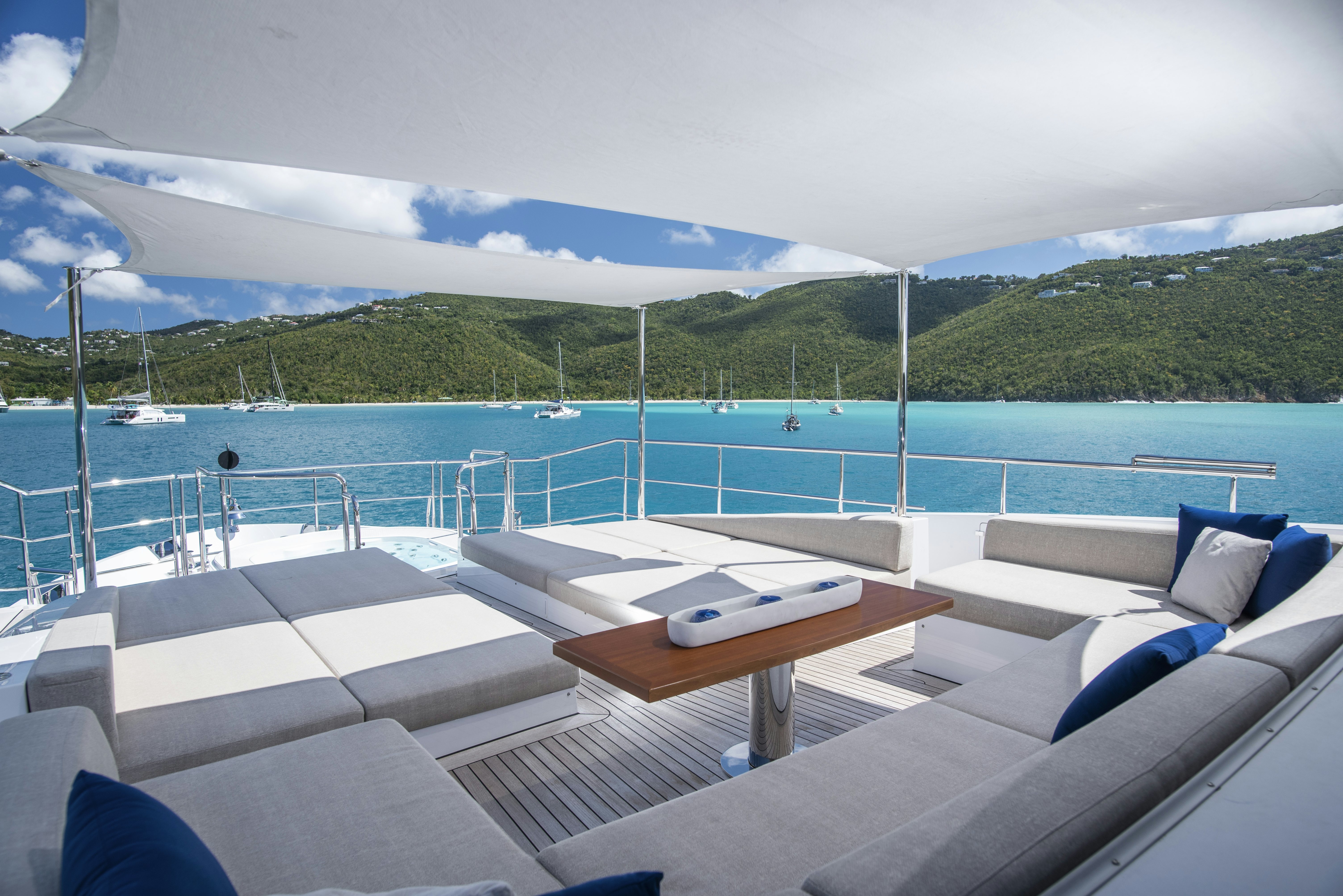 a lounge area with a pool and a view of the ocean aboard WABASH Yacht for Sale