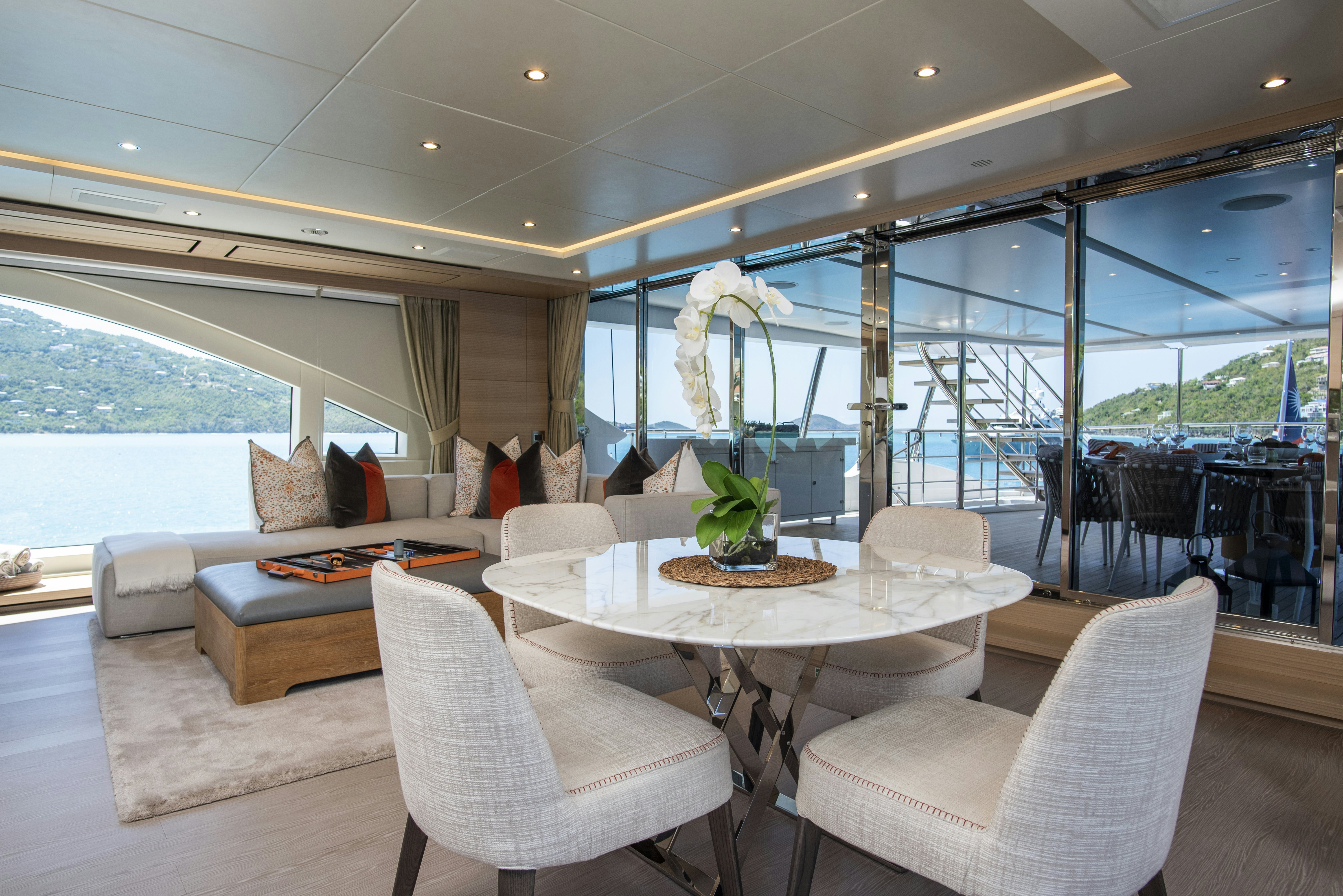 a room with a table chairs and a large window aboard WABASH Yacht for Sale