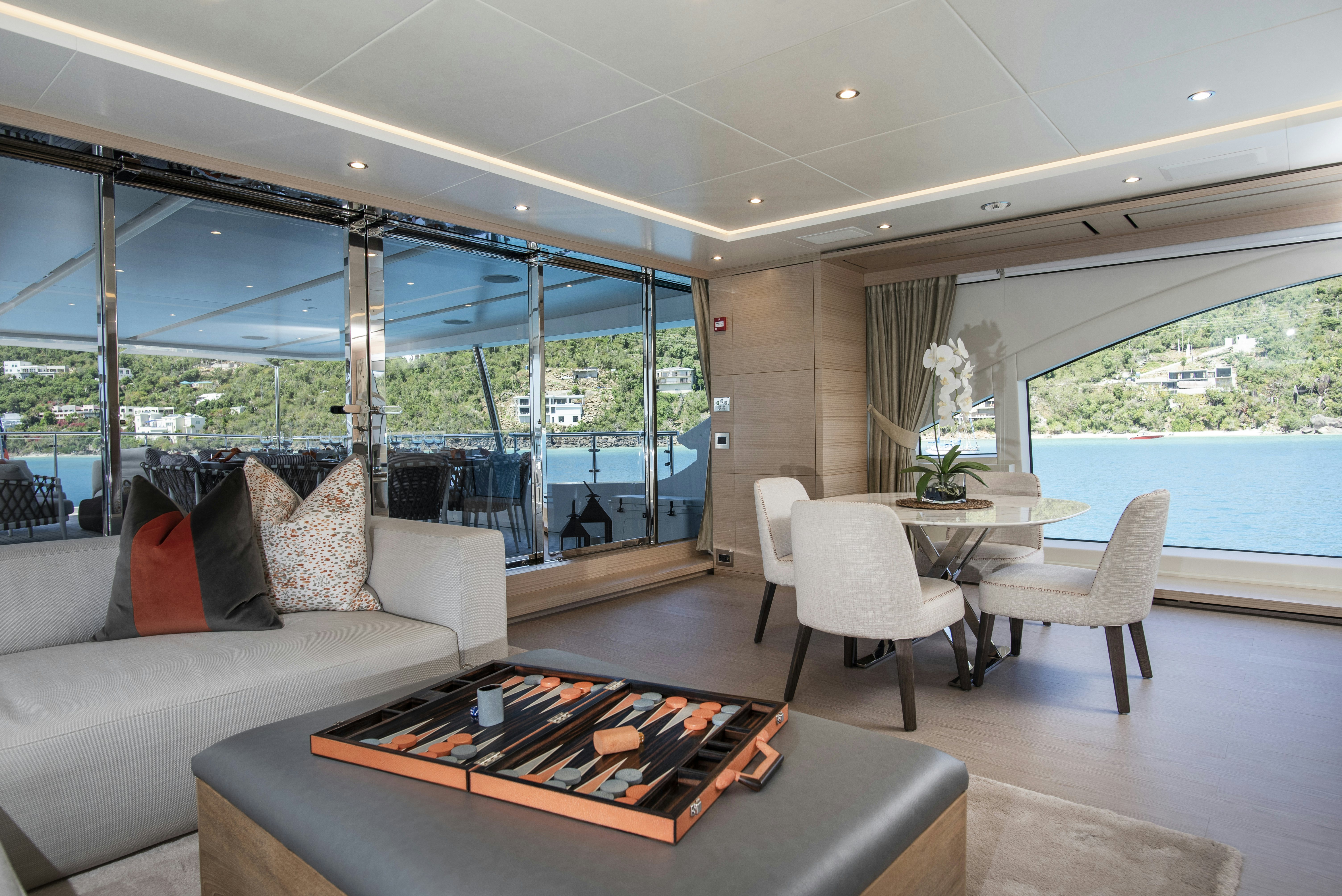 a living room with a large glass window aboard WABASH Yacht for Sale