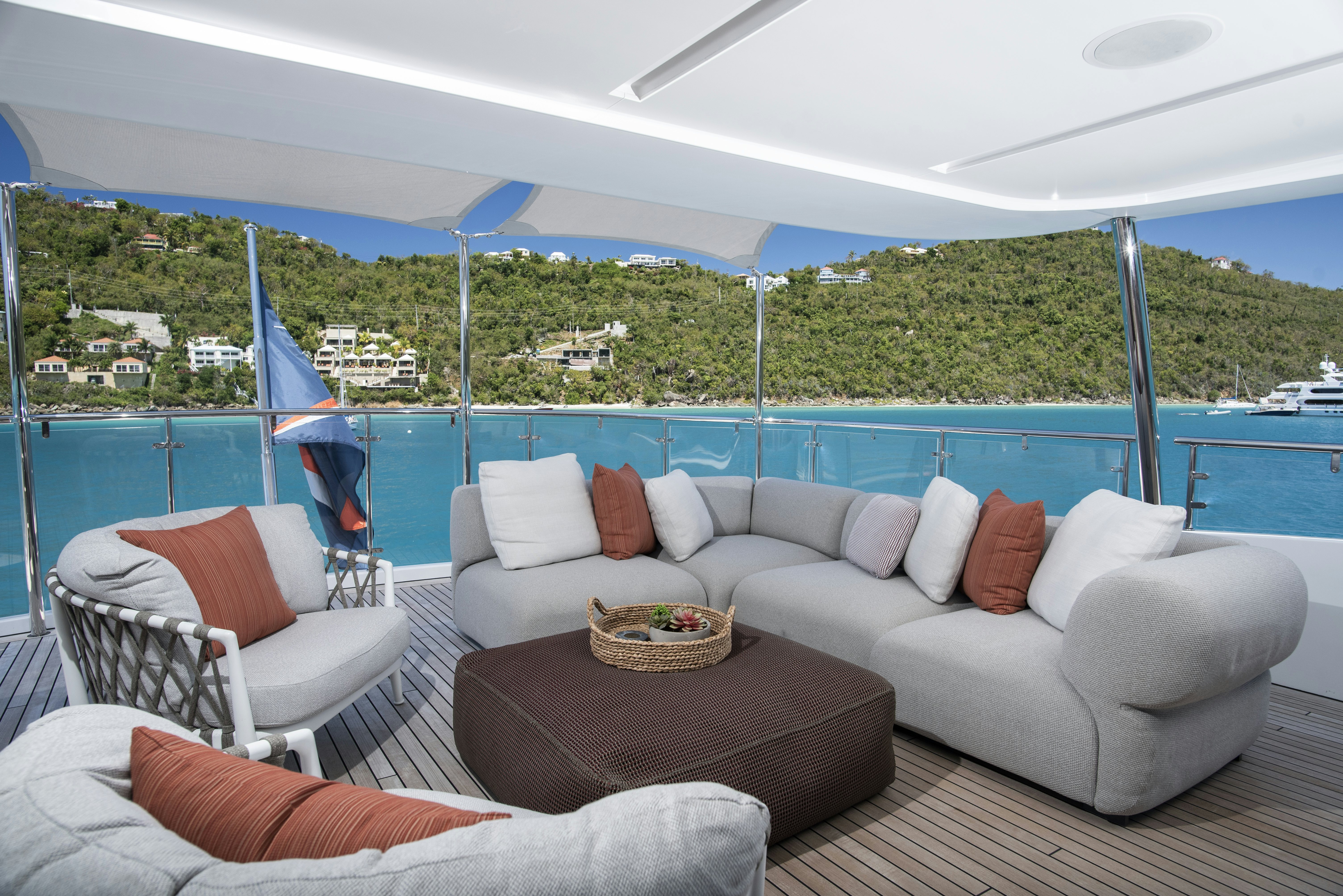 a large white couch with a blue canopy over a large city landscape aboard WABASH Yacht for Sale
