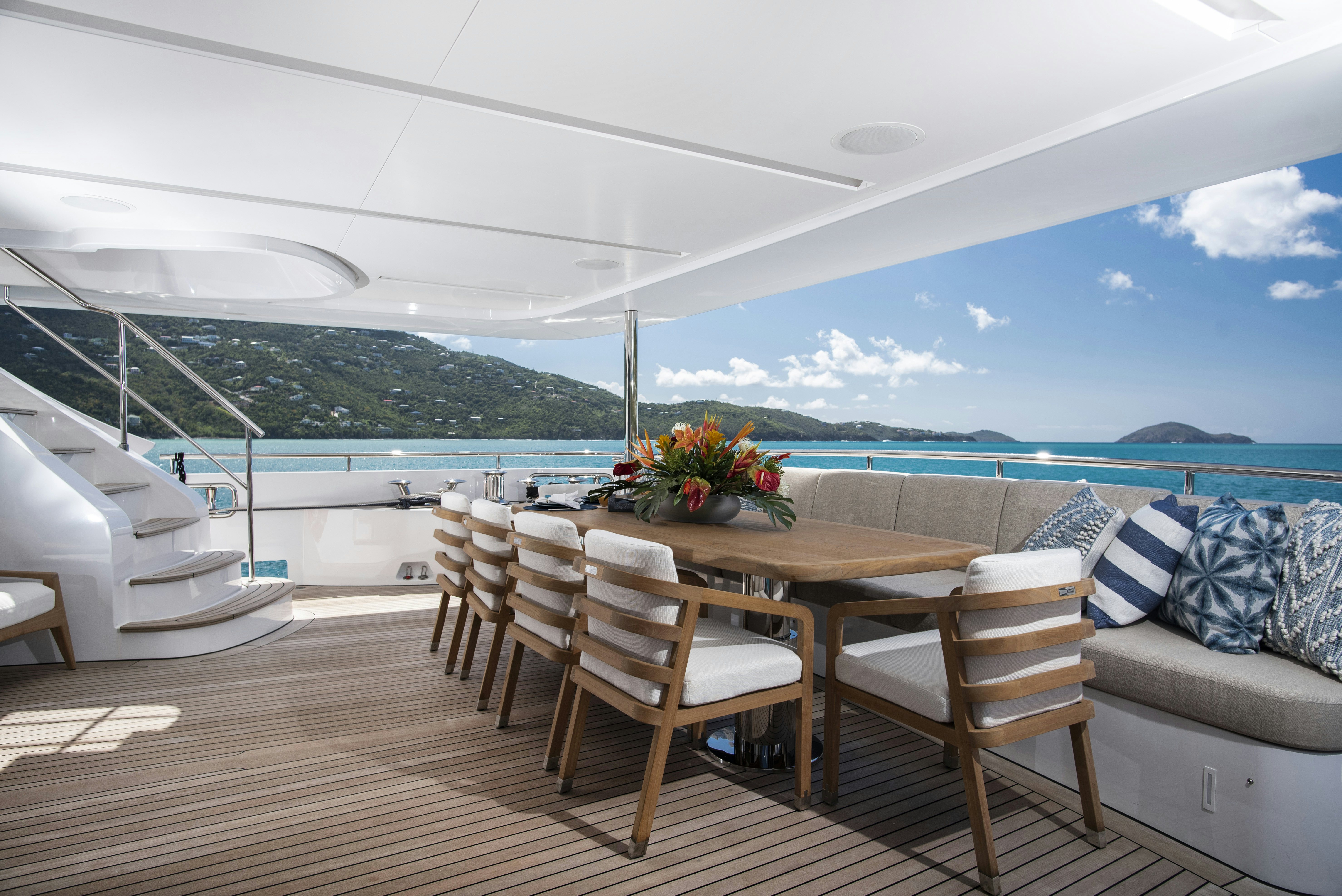 a table and chairs on a deck aboard WABASH Yacht for Sale