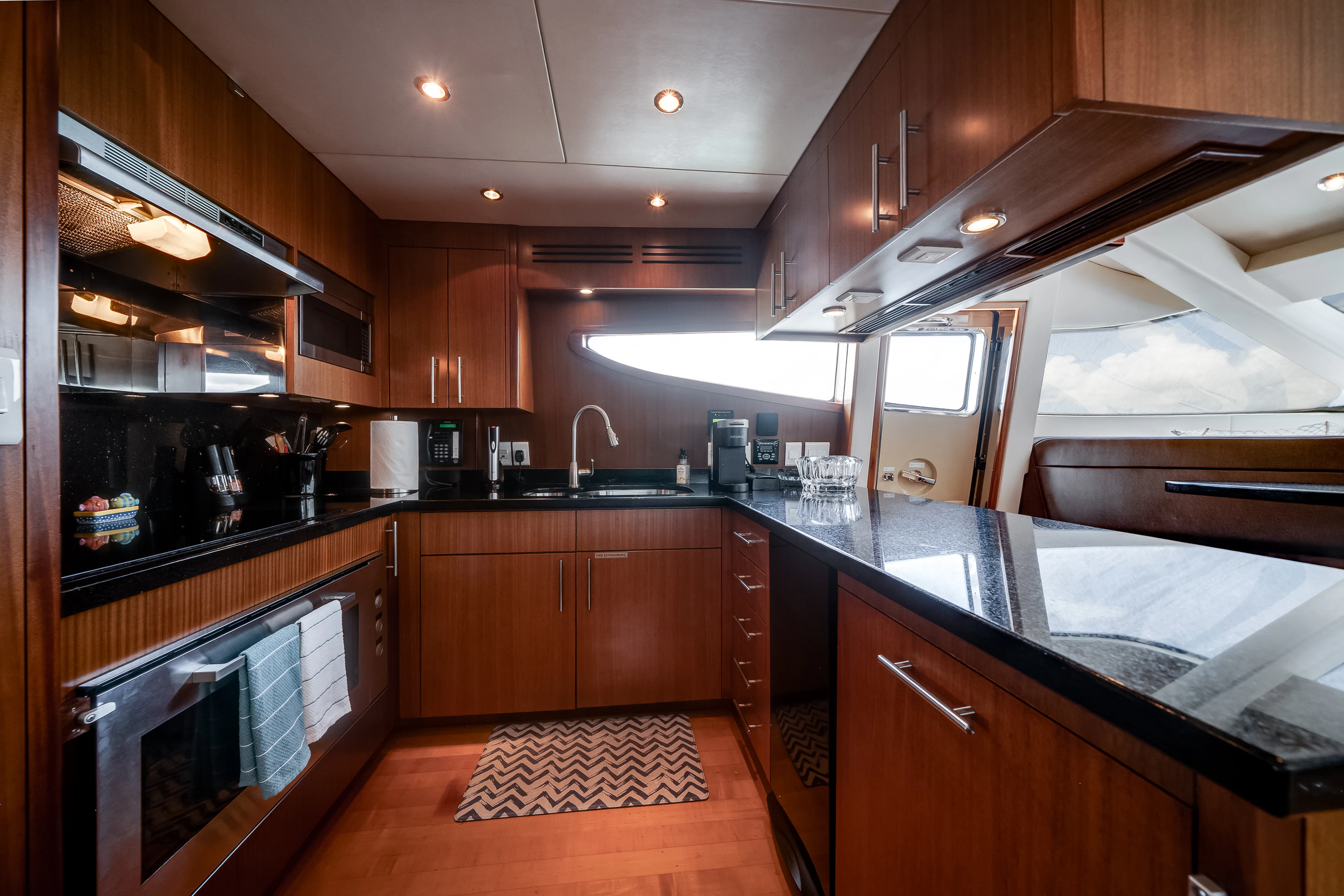 a kitchen with wooden cabinets aboard MR. CHIPS Yacht for Sale