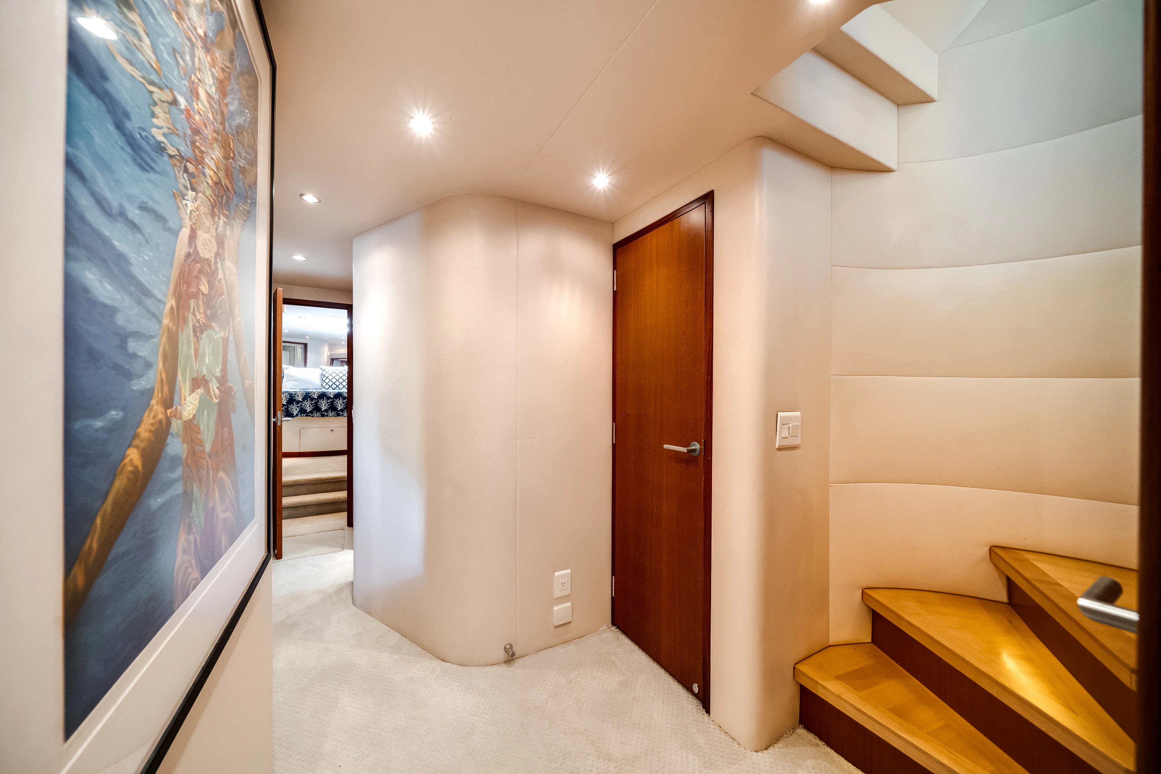 a hallway with a painting on the wall aboard MR. CHIPS Yacht for Sale