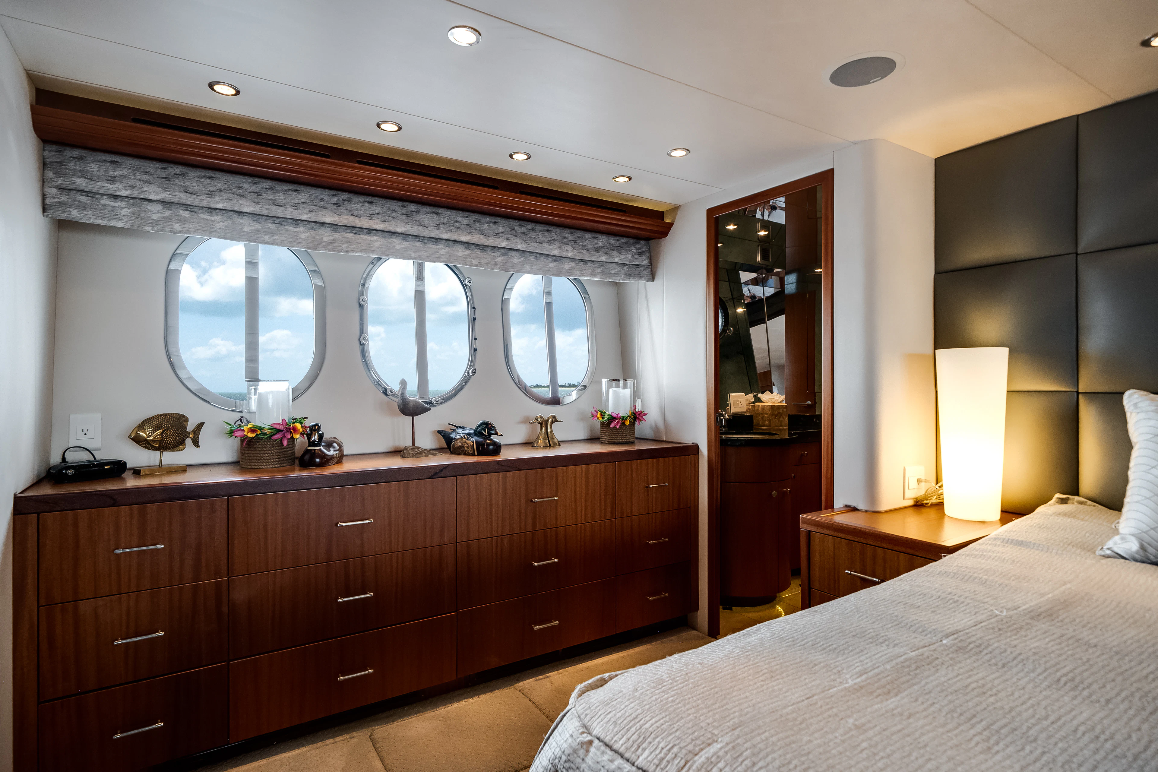 a bedroom with a large mirror aboard MR. CHIPS Yacht for Sale