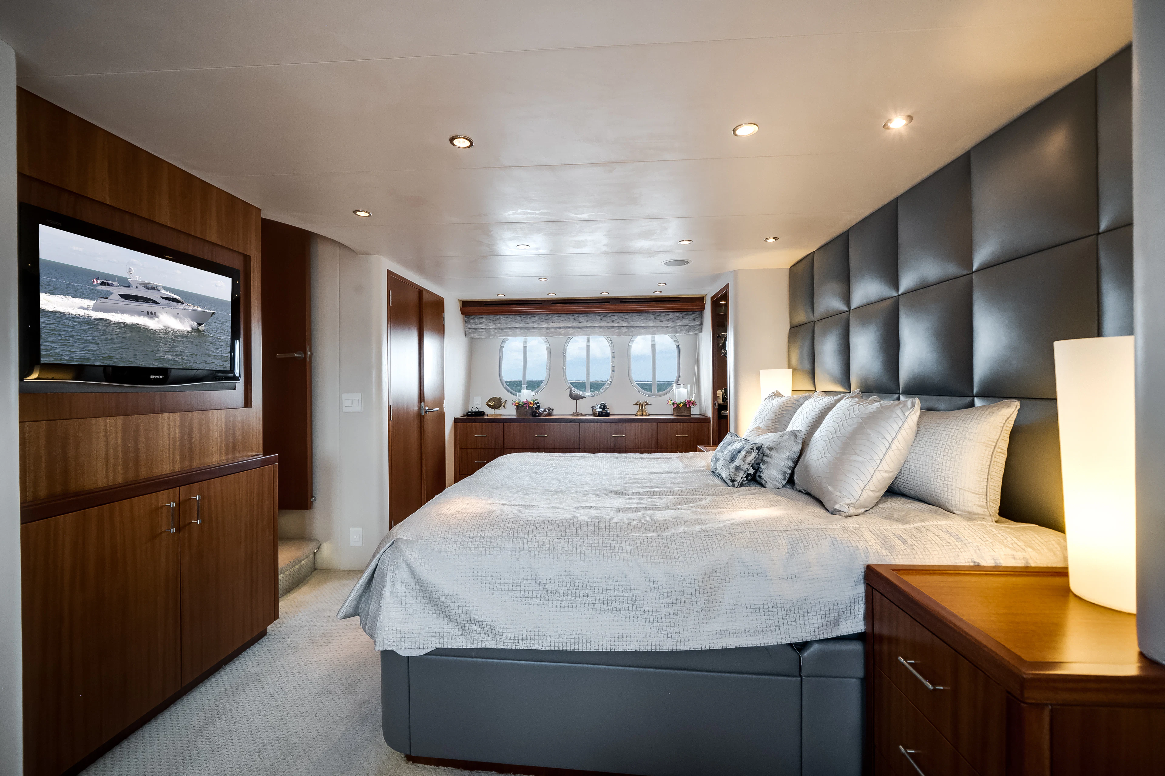 a bedroom with a bed and a television aboard MR. CHIPS Yacht for Sale