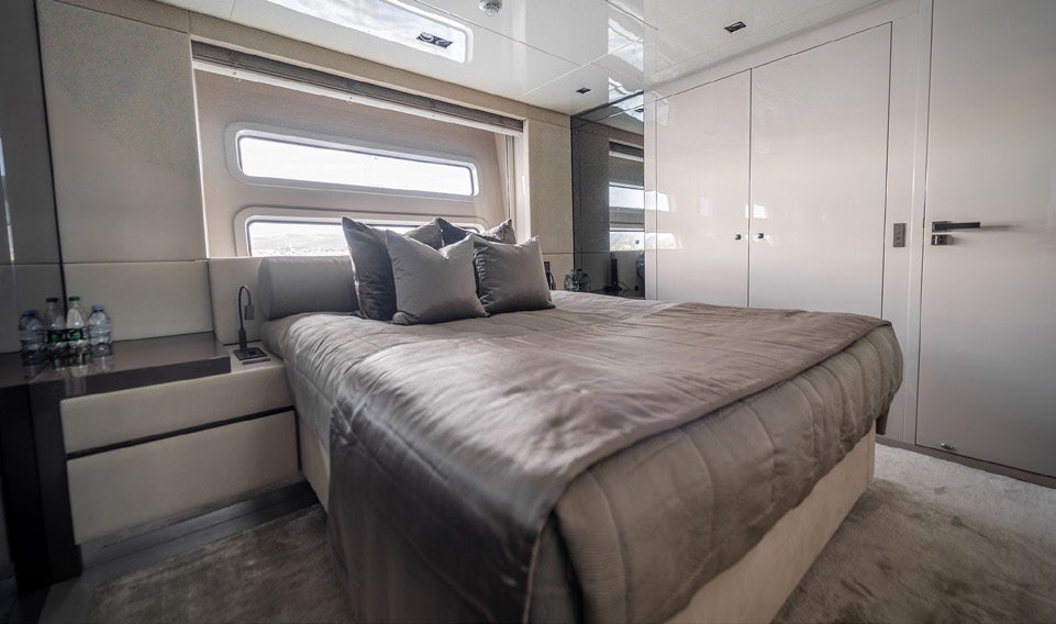 a bed in a room aboard THE PALM Yacht for Charter