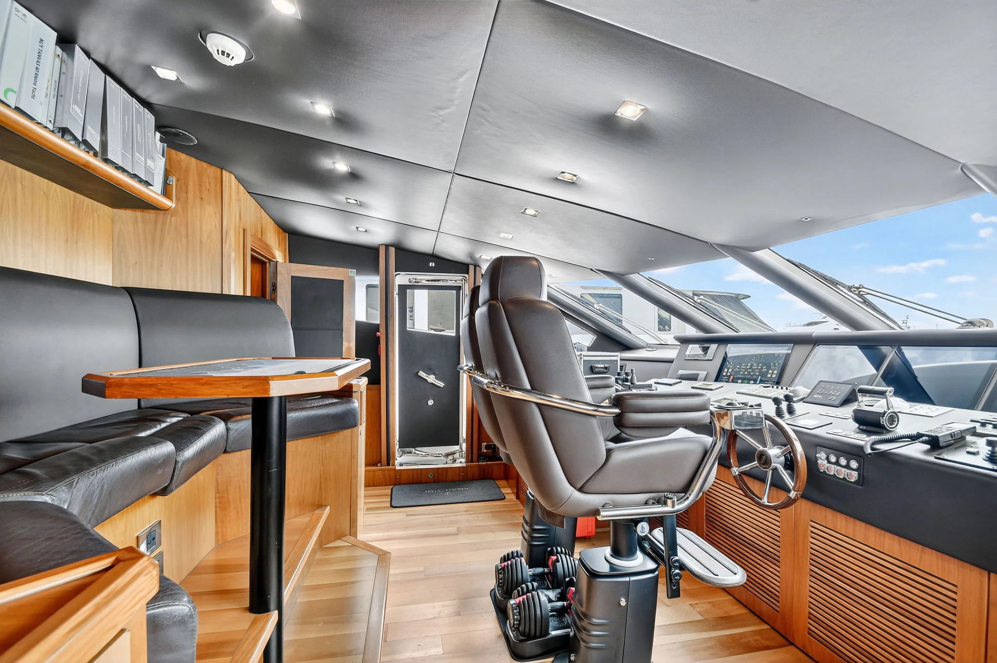 a room with a desk and chairs aboard ABOUT TIME Yacht for Sale