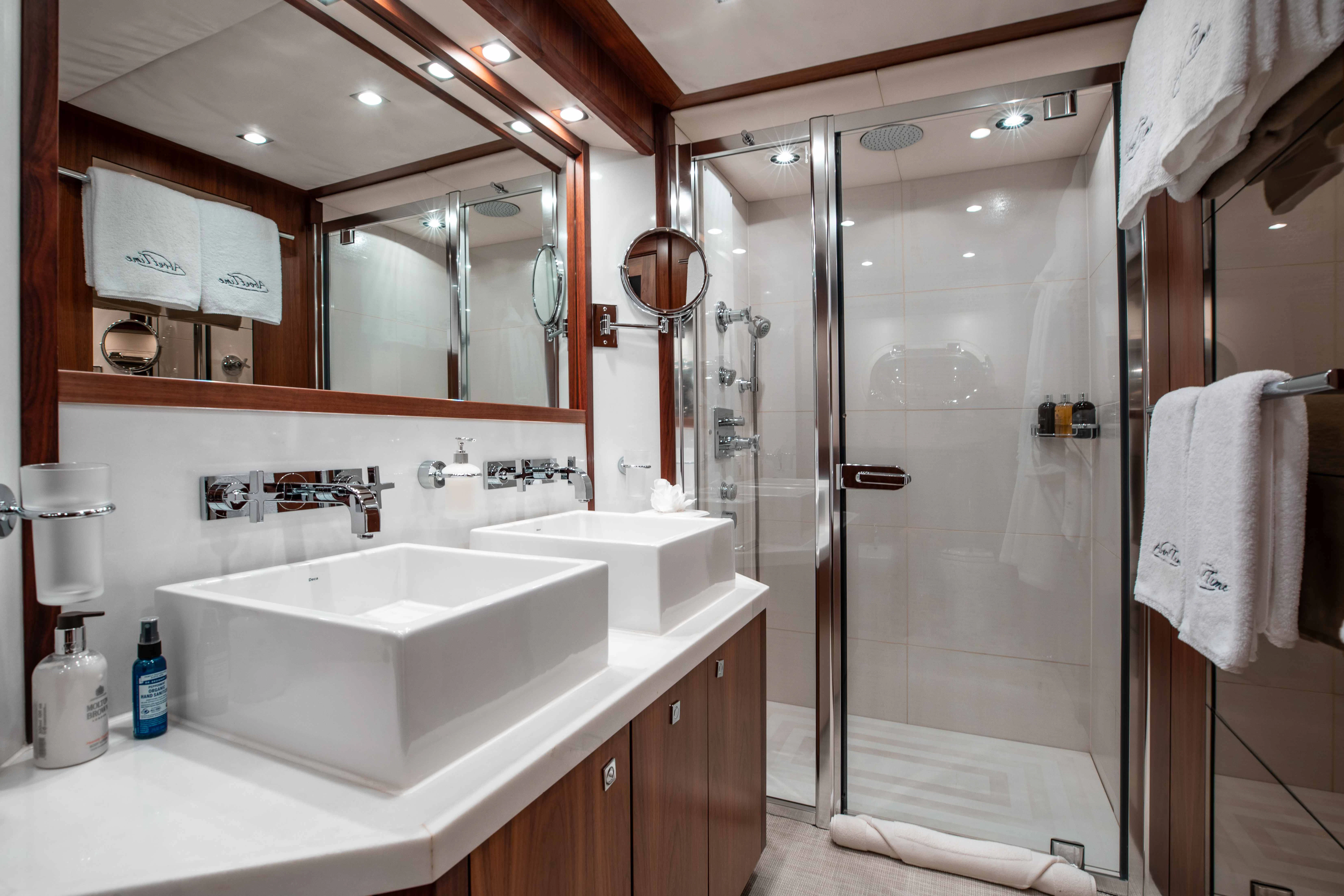 a bathroom with a glass shower aboard ABOUT TIME Yacht for Sale