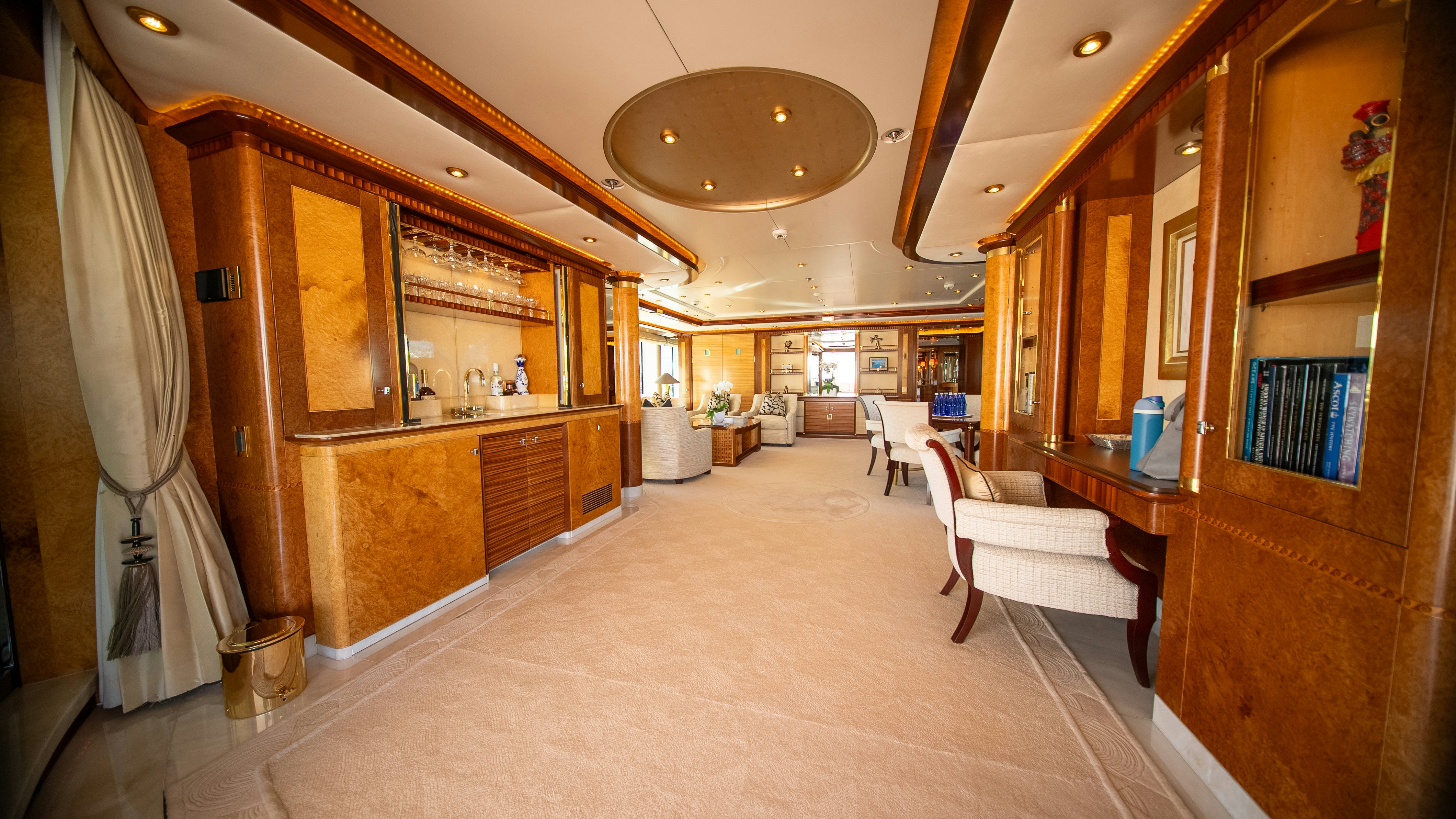 a room with a large mirror and tables aboard LUDZIE Yacht for Charter