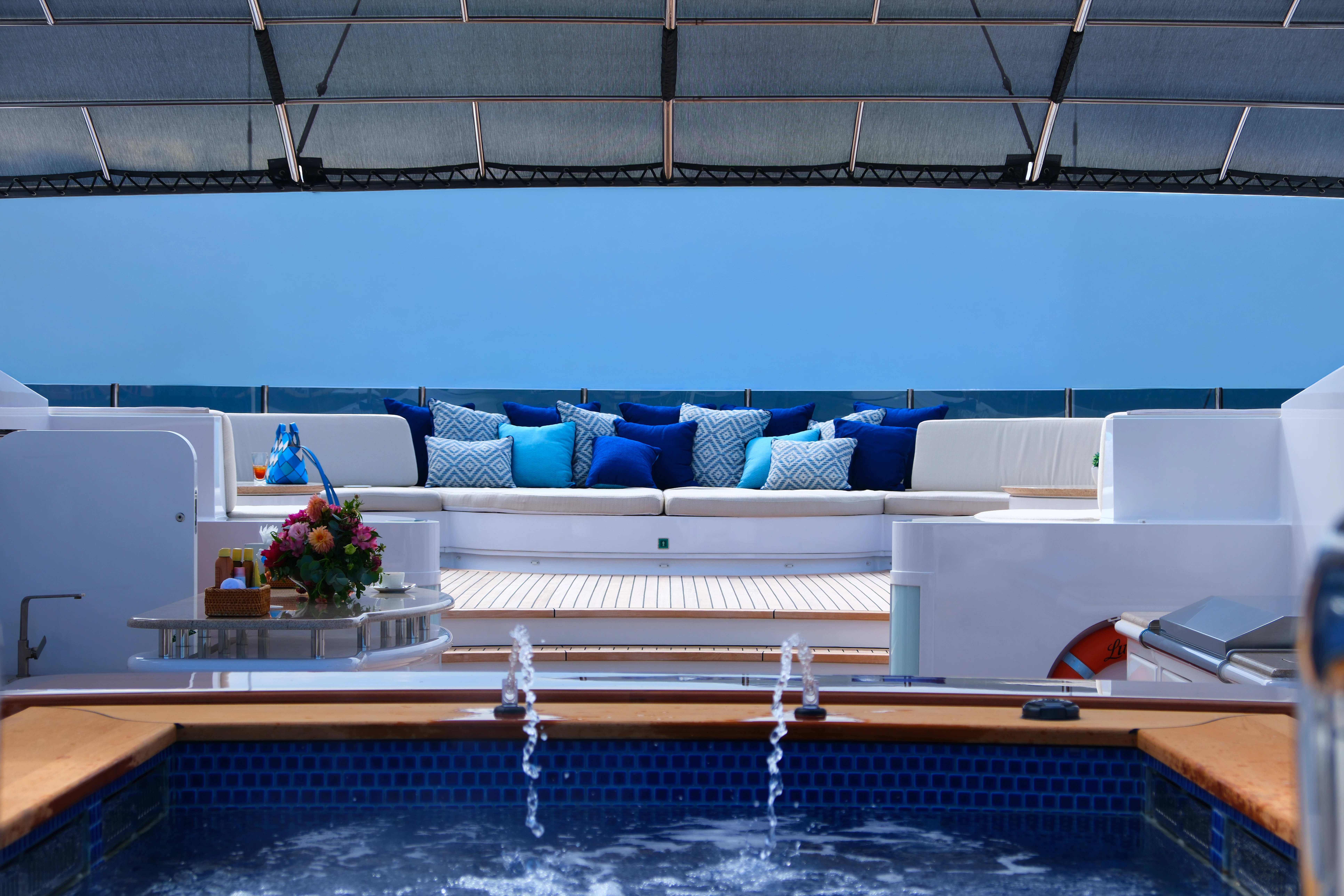 a pool with a couch and a table aboard LUDZIE Yacht for Charter