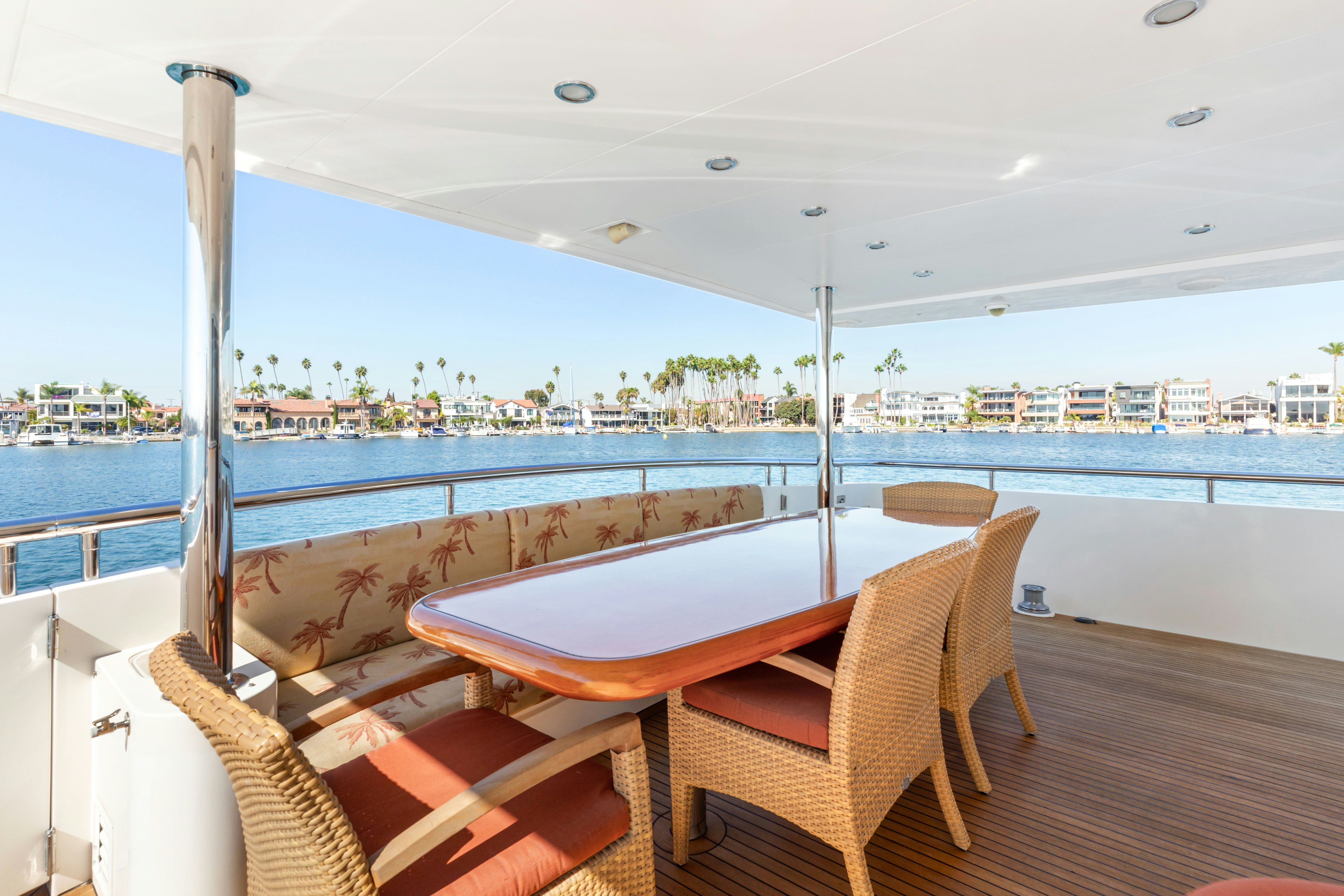 a table and chairs on a deck overlooking a large body of water aboard REVERIE Yacht for Sale